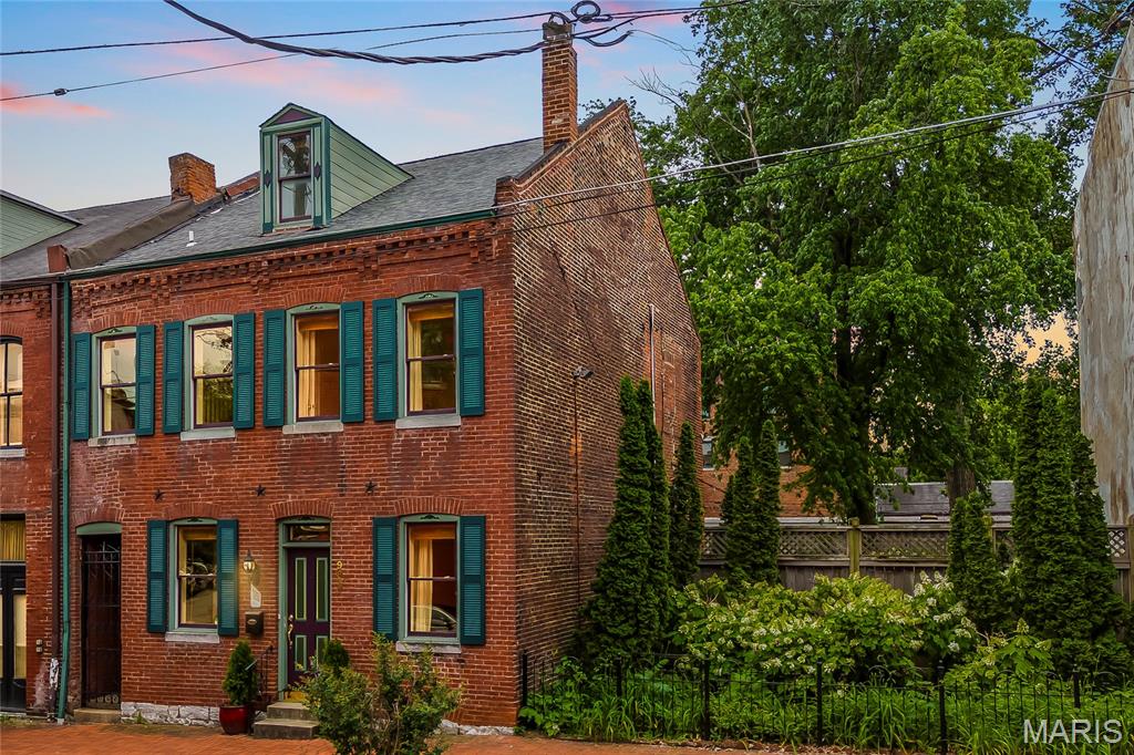 Open Sun, 6/28, 12-2pm. In the soulful heartbeat of Soulard, this beautiful three-story brick home does a flawless job of blending old-school historic charm with all the modern, upgraded comforts you are looking for. The moment you walk through the door, the tall ceilings and gorgeous refinished hardwood floors give the place a warm and inviting vibe. If you love to host, the main level will be your favorite spot. Off the living room is a convenient half bath, and the updated kitchen is open to the living and dining rooms, meaning you can chat with guests and mix drinks without ever feeling cut off from the party.

Take a step outside where the exterior truly shines. The outdoor space is one-of-a-kind for the neighborhood and takes this property to epic status for city living. Sitting on a rare, expansive double lot, the thoughtfully landscaped backyard features a huge deck and a private hot tub that stays with the home. To top it all off, you get a detached four-car garage, a premium feature that is unheard of in the city.

When you are ready to retreat inside, the stunning hardwood floors continue up the stairs and down the second-floor hallway, where you’ll find two spacious carpeted bedrooms and a large, updated bathroom complete with modern tile and a sleek vanity. The primary bedroom is a true sanctuary, featuring a walk-in closet and its own private balcony overlooking the garden, the perfect spot for a quiet morning coffee before the neighborhood wakes up. The cool architectural details just keep going as you’re guided by a stunning exposed brick wall to the third floor. There you’ll find a versatile space just waiting to become your quiet home office, an awesome media room, or a huge third bedroom.

If you thrive on a good night out, you’re in the absolute prime spot. This is Mardi Gras central, putting the neighborhood's best pubs, live music, and restaurants right at your doorstep. You’re steps away from Goshen Coffee Roasters, Historic Soulard Farmers Market, Duke’s, Protagonist Cafe, McGurks, Molly’s, and 1860 Saloon. You'll appreciate the historic churches, brick streets, corner pubs, and architecture full of character. Soulard has a vibe that’s hard to replicate.