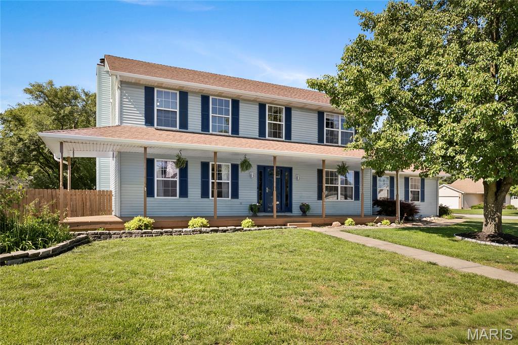 Coming Soon! Showings begin Friday, June 5th but you can take the 3D Tour today! Welcome home to this charming two-story on a large, corner lot, where a full wraparound covered porch and a side-entry two-car garage (finished with service door) set the tone the moment you arrive. Inside, a sunlit foyer opens to a flexible front study, formal dining room, and a refreshed kitchen with painted cabinetry, a tile backsplash, stainless appliances (all staying!), and a pantry with slide-out shelving. The breakfast nook and bay-windowed family room — anchored by a gas fireplace — flow through French doors to a large covered deck overlooking a flat, fenced backyard with a storage shed and room for a future pool. Upstairs, retreat to a spacious vaulted primary suite with a walk-in closet and luxury bath featuring a whirlpool tub, double vanity, and separate shower. Three more bedrooms with new carpet, a full hall bath, and a convenient upstairs laundry complete the level. This home features solid wood six panel doors, ceiling fans, predominant laminate and LVP flooring, The partially finished lower level adds a recreation room with built-ins, a flexible office or bonus room, 1/2 bathroom (plumbing is there to make a 3/4 bath), plenty of storage in the unfinished area and a sump pump with battery back up. Recent updates include newer gutters, repainted interior, garage door, some interior lighting, deck boards, carpet and lvp flooring, storage shed, bathroom updates and miscellaneous items throughout. Ideally located minutes from Scott AFB, shopping and conveniences, restaurants, MetroLink and quick I-64 access to O'Fallon and downtown St. Louis. Schedule your showing today!