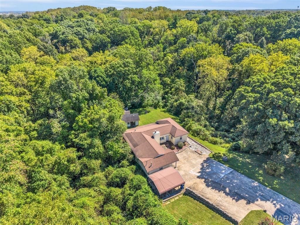 This is an incredible ranch home with over 1500 square feet sitting on 3.16 acres.  Great setting.  Surrounded by trees.  All to be enjoyed with the wrap around screened in porch.  Three bedrooms, full bath, and 2 car carport.  Water Heater is 4 years old.  Roof and HVAC are 10 years or less. Come check it out!