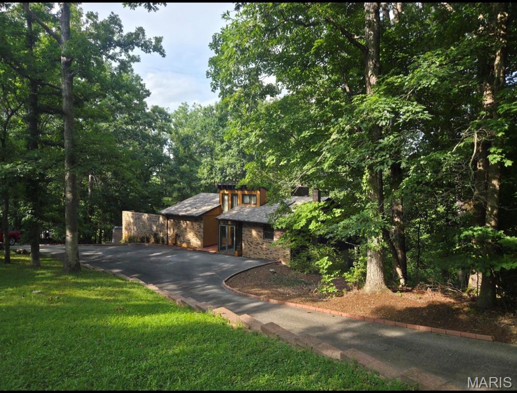 Opportunities like this don't come around often. Tucked among mature trees, in a sought-after neighborhood, this architecturally striking contemporary home offers soaring ceilings, exposed beams, dramatic walls of glass, an open loft, and a layout designed to bring the outdoors in.
The home is ready for a complete cosmetic renovation, giving the next owner the chance to create a truly custom masterpiece instead of paying for someone else's design choices. With its exceptional architecture, abundant natural light, and timeless contemporary style, the hard part is already here—the vision is yours to bring to life.
Whether you're an architecture enthusiast, an investor, or someone searching for a forever home unlike anything else on the market, this is a rare opportunity to restore an incredible property to its full potential. Home being Sold As IS, Seller to make no repairs or remedies.