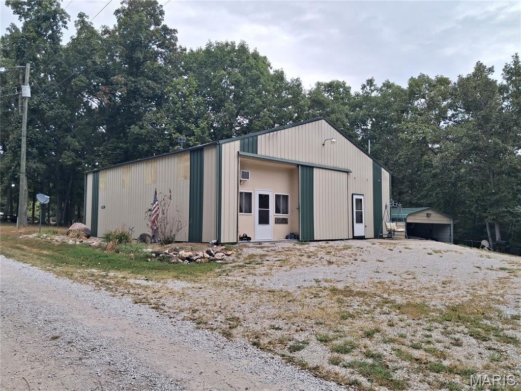 Four bedroom, one bathroom 2015 built shouse sitting on 2.8 m/l acre lot located about 6 miles from the Spalding beach/boat ramp of the Mark Twain Lake. Outside of the home, there are 4 camper sites to have your friends come and stay to enjoy the lake activities and to hang out around the firepit after a long day out on the lake. The 2.8 acres is mostly wooded for a park like atmosphere. Several outbuildings will convey with the sale. There is a 30x40 outbuilding with electric and gravel floor, along with a 18x22, 18x30, and a 18x32 carports, and a 8x48 storage container.