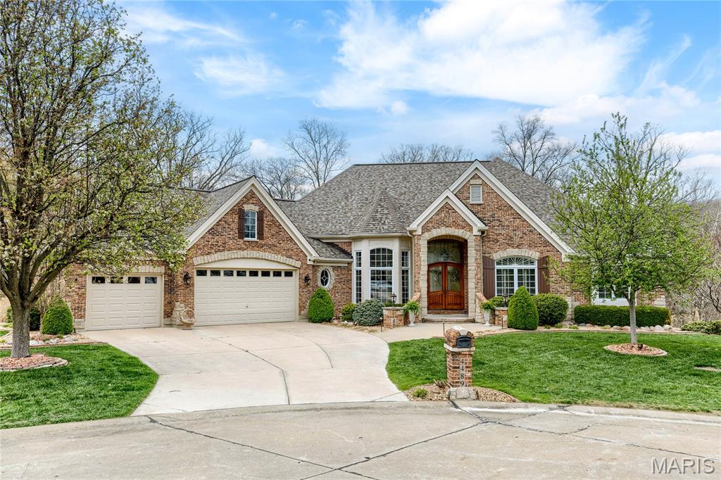 This spectacular Cross-built great room ranch features distinctive design elements & builder upgrades throughout including oak hardwoods, 13' ceilings, detailed trim work & an integrated sound system. Impressive hardwood foyer leads to well-appointed study, formal dining room framed by architectural columns and stunning great room with dramatic wall of windows with private wooded views. Custom-designed kitchen with cherry cabinetry, granite countertops, GE Monogram appliances & 8’ center island adjoins breakfast room with convenient planning center & hearth room with groin vault ceiling & floor-to-ceiling stone fireplace. Coffered primary bedroom suite with luxury bath with shower spa plus a 2nd ensuite bedroom complete the main floor living quarters. Lower Level entertainment space includes recreation room with brick & stone fireplace, game room with wet bar, workout room, 2 additional ensuite bedrooms & half bath. Situated on a .46-acre cul-de-sac lot with deck, patio & 3-car garage.