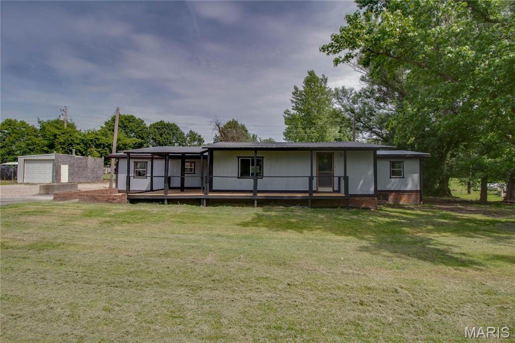 Come check out this 2 bed ranch style modular home on a secluded country road. Lots of parking, an additional shed for storage or a small workshop. Large covered porch for relaxing or entertaining. This home boasts a metal roof, spacious living area, main floor laundry, fresh paint and new flooring. Come take a look at this conveniently located home in between Godfrey and Jerseyville.