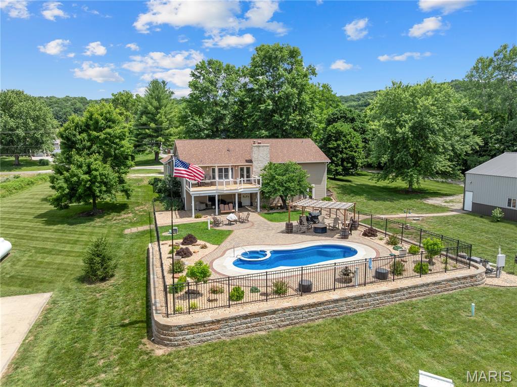 Spacious Ranch on 3.5 Acres just 12 minutes to Washington.  The main level has 3 bedrooms, 2 full baths, fireplace, cathedral ceiling, wood floors, heated ceramic floor in kitchen/dining room.  Full walk out basement with bedroom, office full bath with whirlpool tub.  Step out to a covered patio to the pool, hot tub area, basketball court.  40X65 Outbuilding, heated and cooled, water, plumbed for compressed air, workshop, 12 foot ceilings with extra concrete for car lift.  Also there's a 14X65 lean to with 30 electric for RV.  This property has it all everything is in great shape newer everything including fully equipped kitchen, high efficiency furnace, newer roof.  High Speed Internet.