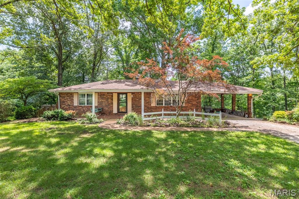 This one won't last long. Just outside city limits a 3 bedroom 2 bath brick home sitting on little over 2 acres m/l. Home has central heat and air with a walkout basement with large family room with a wood stove for back up heat. Home is sitting in a park like setting with large trees in front and back yard. Seller had a garden spot for vegetables and a detached barn for storing your equipment.