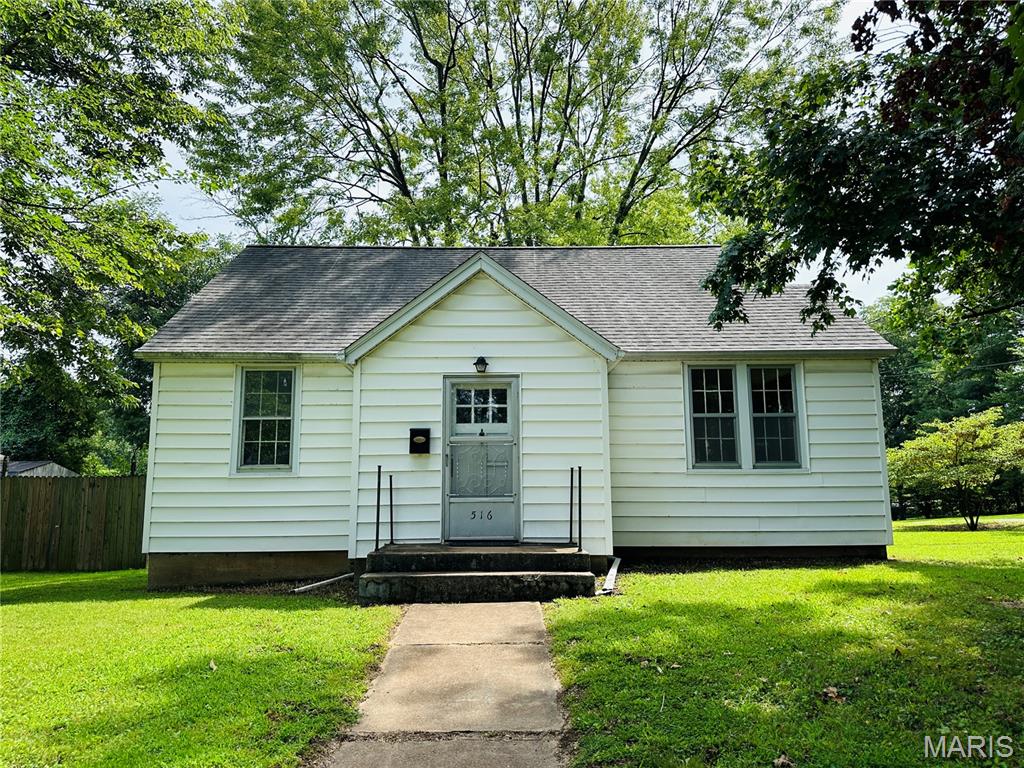 So darn cute and waiting for you to put your personal touch on this adorable cottage!  This home with detached garage sits on a corner lot in the quiet section of historical Lebanon, Illinois.  The home is only one block from the private McKendree University so the commute will be very short.  All rooms have the original hardwood floors except the kitchen and bathroom.  You will love the original gorgeous French Doors which separate the living room from the rest of the home.  The living room has original electric wall sconces and most doors have the original glass doorknobs.  This cozy home has a foyer with coat closet and a lot of character. In the basement you will find the gas boiler, a separate gas heater for the basement, laundry and plenty of space for storage or a hobby area.  The detached garage with opener completes this great property.  The home has a newer 200amp breaker box and mostly new wiring.  Buyer and buyer's agent to verify all information. Property is being sold 100% AS IS. Seller will not do any inspections, repairs, or credits for repairs. Buyer will be responsible for the occupancy inspection after buyer takes possession.