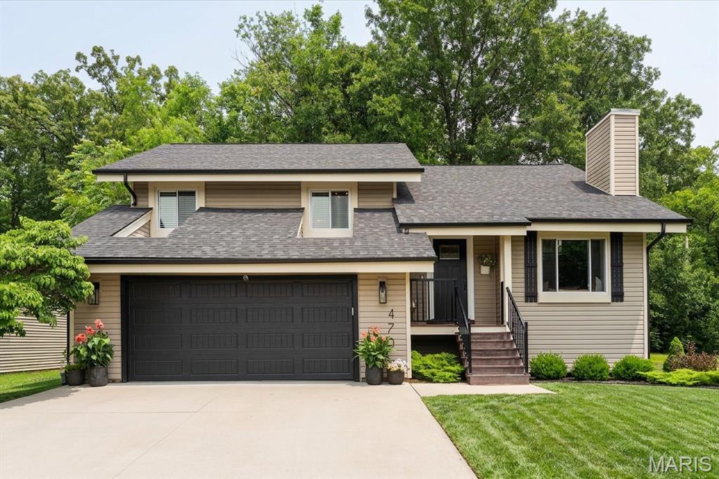 Welcome home to 470 Oak Hill Drive, a beautifully reimagined 4-bedroom retreat on a quiet Lake Saint Louis cul-de-sac, backing to mature woods. Inside, an open-concept main level unfolds beneath soaring vaulted and cathedral ceilings, with wide-plank luxury vinyl flooring and a showstopping floor-to-ceiling stacked-stone gas fireplace framed by custom built-ins and a cushioned window seat.
The updated eat-in kitchen is the heart of the home, featuring white shaker cabinetry, granite counters, a center island with breakfast bar, subway-tile backsplash, stainless steel appliances, and a striking marble coffee bar, all opening to a dining area that walks out to the deck. The spa-style primary suite offers a walk-in closet, and a fully renovated bath with heated floors, a double quartz vanity and a walk-in marble rainfall shower. Two more bedrooms, one styled as a dedicated home office, and a stylish hall bath complete the upper level.
The finished walk-out basement adds real, usable living space, including a large family room, a fourth bedroom, and a third full bath, opening to a covered patio and a level, tree-lined backyard built for fire-pit nights. An oversized two-car garage plus a separate workshop and storage room mean room for everything.
Move-in ready and worry-free: a newer Class-3 impact-resistant roof and LeafFilter gutters (both with transferable warranties), plus a 2020 heat pump, central A/C, and water heater. As part of the Lake Saint Louis Community Association, you are minutes from two private lakes, a nine-hole golf course, the clubhouse and pool, and tennis and pickleball. Zoned to sought-after Wentzville Schools (Timberland High).
Four bedrooms, three full baths, a finished walk-out lower level, an oversized garage, and a private wooded lot. This one is turn-key and waiting. Schedule your tour before it is gone.