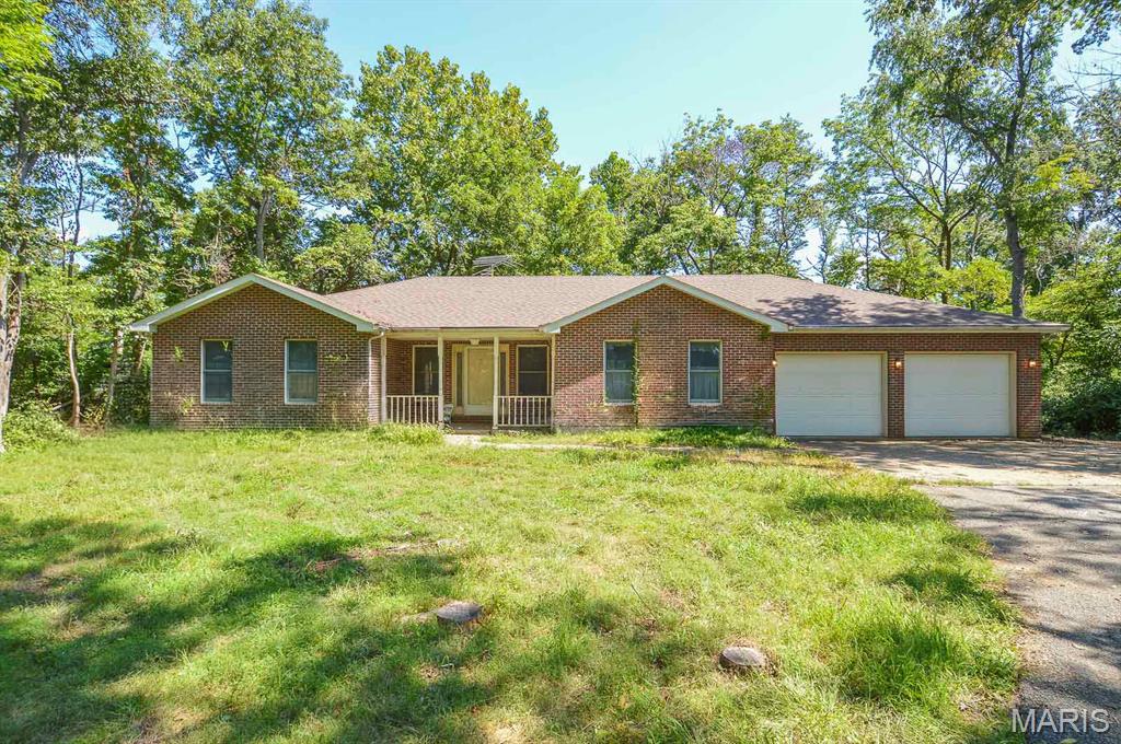 Price listed is Starting Bid Only. Bidding starts closing 10/28/2026 @ 6 p.m.  A rare opportunity awaits with this spacious 4BR/4BA home set on 12± mostly wooded acres in Freeburg, Illinois. Surrounded by mature timber, the property offers exceptional privacy, abundant outdoor space, and the flexibility to selectively clear portions of the acreage for future development, subject to zoning and approvals. The setting provides a peaceful retreat while remaining conveniently close to local amenities and within the Freeburg School District. The main level welcomes you with a tiled entry that opens into a generous living room anchored by a propane fireplace. An open kitchen and dining area provide ample cabinetry, extensive counter space, and a center island ideal for everyday use. The private primary suite features two oversized walk in closets and a spa like bath complete with a soaking tub and separate shower. Rounding out the main level are two additional bedrooms, a full bath with a functional laundry/mudroom leading to the attached two car garage. The full walk out lower level expands the home’s living space with a fourth bedroom, a bonus room offering potential for a fifth bedroom, and a full bath. An expansive recreation area includes a second propane fireplace, a pool table, and sliding glass door that open to the outdoors, creating a seamless connection to the surrounding acreage. A tuck under single car garage with a half bath adds even more versatility to the layout. Garage and storage space are standout features of this property. In addition to the attached, two car garage and tuck under, one car garage, a detached, three car garage with a poured concrete floor provides exceptional room for vehicles, equipment, hobbies, workshop use, or additional storage needs. Mine subsidence damage previously identified on the property has been repaired, and the associated claim has been settled with no remaining monetary balance. This unique offering combines privacy, space, and flexibility in a desirable location, creating an ideal setting for those seeking both comfort and room to grow. Property will sell under auction terms and be sold AS- IS, WHERE-IS. Seller, will not make any repairs as a result of any building, occupancy, or environmental inspections. Buyer will be required to sign an Auction Purchase & Sale Agreement if final bid is accepted by Sellers.