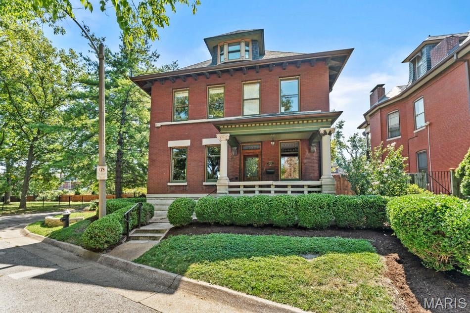 Built for the Plass family in the late 1890s, 3248 Copelin Avenue stands along the Compton Heights street once known as “Millionaires’ Row.” The Victorian residence retains an exceptional collection of original details, including hardwood floors, pocket doors, etched-glass windows and transoms, restored brass hardware, six tile fireplaces, and much of its original lighting. The foyer features decorative hand-painted walls, a treatment that continues into the living room and along the stairwell. Original pocket doors connect the living and dining rooms, while the dining room has its own fireplace and a curved bay of windows. The freshly painted kitchen opens directly to the rear patio, and a marble-clad powder room completes the main level. A striking curved bay of original stained glass illuminates the grand staircase. Above, a ceiling mural by local artist Mark Sova draws on historic Bradbury & Bradbury designs. The second floor offers three bedrooms, a full bath, and a moody den decorated with hand-painted chinoiserie. Spanning the entire third floor, the spacious, light-filled primary suite includes an expansive walk-through closet and a bath with heated floors and a steam shower. Set on an impressive corner lot, the property also offers a fenced yard, an inviting garden sitting area, and an oversized two-car garage. This remarkable home pairs its preserved Victorian character with thoughtfully incorporated modern comforts.