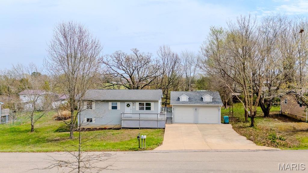 Discover this spacious 4-bedroom, 2-bath home with a finished, walk-out lower level, a detached, heated 2-car garage, a wrap-around deck, and a large backyard with a charming Playhouse and a Lawn Shed.   The garage offers workshop space and storage.  Located near city parks and local schools, this home offers a perfect mix of comfort, convenience, and small-town charm.  Move-in ready with flexible space for whatever you need, this home has it all!  Schedule your appointment today!