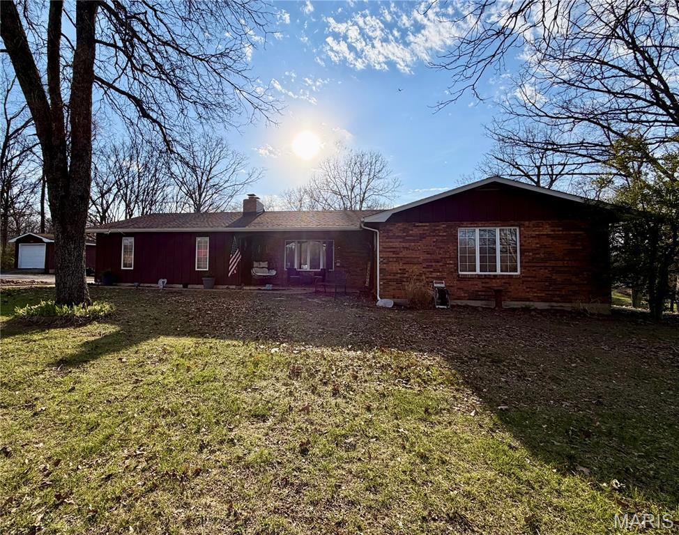 This spacious home, located on the outskirts of town, boasts 3 bedrooms (6 total), 3 situated on the main floor and 3 on the lower level, (two w/o windows). Nestled on 3.2 m/l acres in a prime location, the property includes a generously sized yard and a completely renovated lower level. On the main floor, you will find a master suite, a separate dining room with sliding doors leading to the deck, two full bathrooms, a large family room with a wood-burning fireplace, and a kitchen equipped with custom cabinetry. The walk-out lower level has been entirely remodeled and is designed to impress, featuring 3 additional bedrooms (two without windows), a game/toy room, a bar area complete with a sink and mini fridge, French doors outside, a laundry/utility room, and another full bathroom. The oversized garage offers ample storage space and room for a workshop, while an additional shed with a roll-up garage door provides convenient storage for yard equipment. The property is accessed via a paved circular driveway that includes a beautifully landscaped island. This home has tons of storage space, large bedrooms and walk in closets.