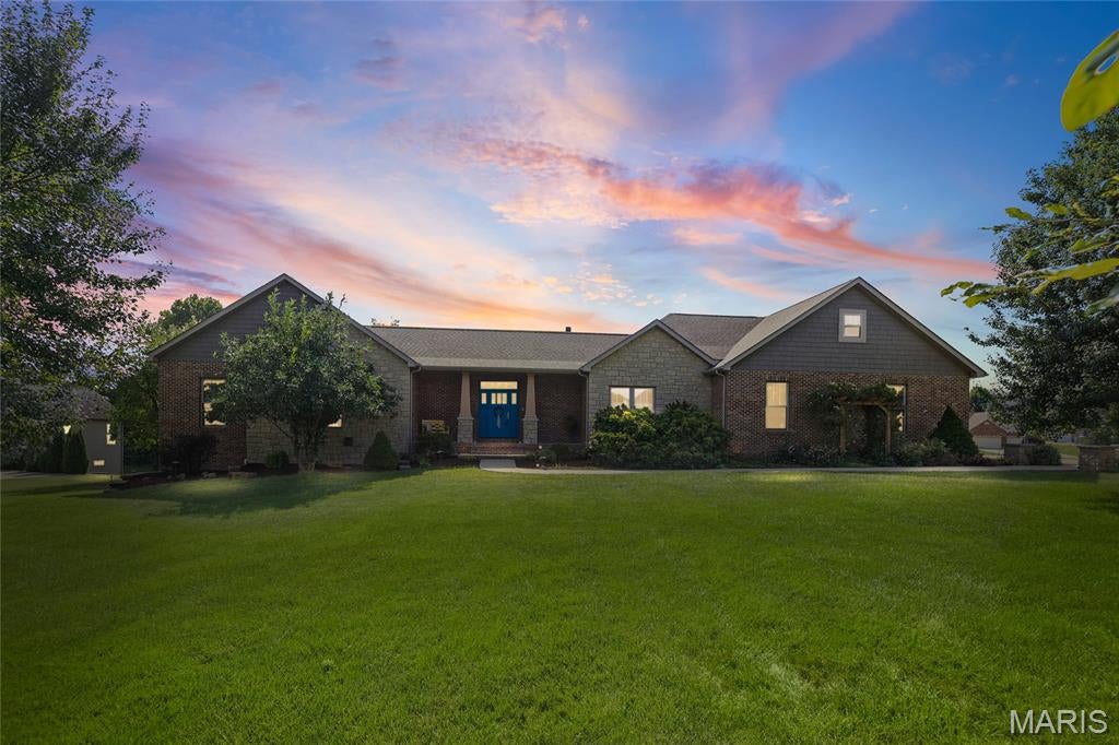 Welcome to this beautifully designed custom built ranch-style home, offering the perfect blend of comfort, functionality, and timeless style. Situated on a spacious 1-acre lot, this 4-bedroom, 4-bath home features an oversized 3-car garage and exceptional living spaces both inside and out. The expansive great room is the heart of the home, showcasing soaring vaulted ceilings and a stunning floor-to-ceiling fireplace. Entertain with ease in the formal dining room or gather in the spacious kitchen, complete with quartz countertops, two sinks, double ovens, a large island featuring a walnut butcher block countertop, and a generous walk-in pantry. Designed with both everyday living and entertaining in mind, the dual-sink layout makes hosting effortless. All kitchen appliances stay, making this home truly move-in ready. The primary suite offers a peaceful retreat with a spacious walk-in closet and a luxurious en-suite bath featuring an extra-large air jet soaking tub,  two sink vanity, an oversized walk-in shower with dual shower heads creating a spa-like sanctuary. The partially finished walkout basement features 9-foot ceilings and maintenance-free stained concrete floors, creating a bright, stylish, and durable space for everyday living and entertaining. The lower level includes, two spacious bedrooms, a full bathroom, a large family room, an impressive 12-foot wet bar with quartz countertops, an additional fireplace and direct access to the patio and private backyard. A convenient workshop provides the perfect space for hobbies and projects. Additional highlights include abundant storage space and a dedicated dog grooming station. For added peace of mind, the home is equipped with a whole-house generator, ensuring reliability year-round. Every detail of this custom-built home reflects quality craftsmanship and thoughtful design. With its desirable ranch floor plan, premium finishes, exceptional indoor and outdoor living spaces, including 12 X 18 screened in porch with floor to ceiling stone fireplace with AZEK flooring, built in grilling area and picturesque one-acre setting, this home offers the ideal combination of luxury, comfort, and everyday living.