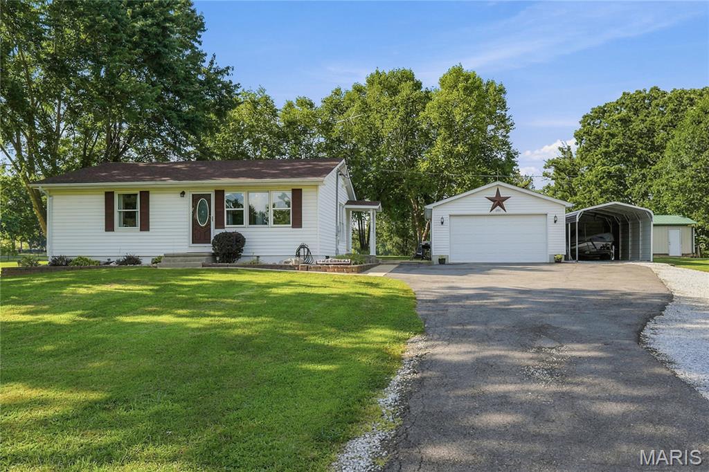 This is a rare opportunity that you’ve been waiting for! Step into this private & charming 2 bed 1 bath home sitting on almost 2 acres that offers far more space than meets the eye. The main level features a large, light filled living room perfect for everyday comfort & entertaining. The spacious kitchen features stainless steel appliances, separate pantry & provides generous room for cooking, gathering & creating memories, while the updated bath adds modern style. Downstairs, the lower level expands your living options with a second family room ideal for movie nights or flexible bonus space. You’ll also find a very large sleeping room that works great for guests, a teen suite, or a private retreat. The property delivers OUTSTANDING outdoor amenities, including a 2 car garage, a 12x12 shed on a slab, a 26x14 outbuilding, & an additional carport—perfect for an extra car or boat, hobbies or additional storage. With indoor & outdoor space like this, you will have room to do all the things you love. Come see it today!