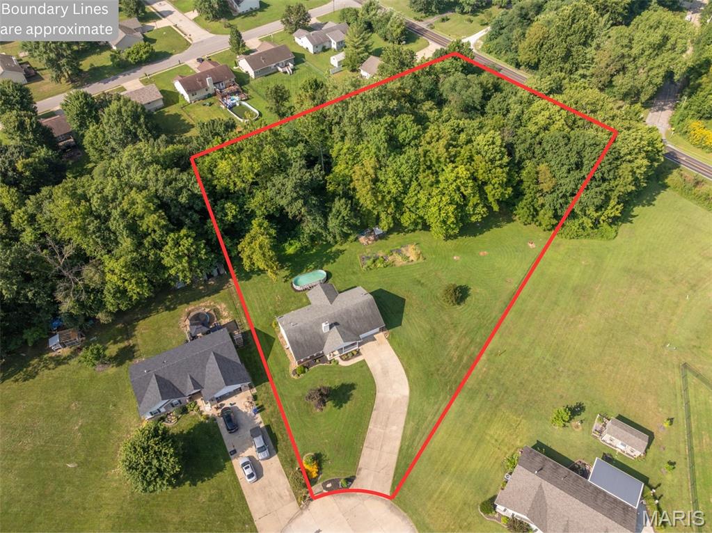 Check out this secluded oasis before it's gone! 39 Scarlet Oak Court checks all the boxes! 4 bedrooms, 2.5 bathrooms with a fully finished walk-out basement for over 3,000 sq ft of living space on 1.66+/-  Acres in Troy, MO! Home features 3 bedrooms and 2 full bathrooms on the main level and a large open living area, optimizing the 1560 sq ft of main level space.  Master bedroom is spacious and has a walk-in closet and en-suite bathroom and has a view of the woods, making for a peaceful retreat at the end of the night. Living room features vaulted ceilings and stone faced wood burning fire place giving it a nice inviting feeling. The eat-in kitchen has an abundance of cabinet and counter space and leads out to the covered back deck, perfect for outdoor summer evening meals. Main floor laundry room is in an ideal location for discarding dirty clothes as you come in from the 2 car garage and has an attached mud room that could be used for a walk in pantry and has outlets for an extra fridge or deep freeze. Downstairs you’ll find 2 large finished rooms that could be used for separate living room, game room, gym or home theater as well as a large bedroom and half bath. One of the rooms also features a wetbar and the basement could easily be converted into a private in-laws quarters. Step out into the back yard where you’ll find an above ground pool, established garden, creek, 12x20 tool/mower shed and enough space for any activity imaginable. The back of the property has mature trees and woods providing plenty of shade and privacy. All of this located in Troy and close to all the amenities it has to offer!