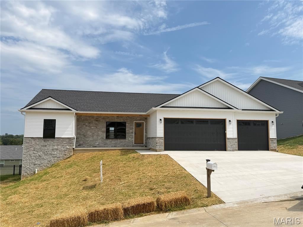 Some homes check boxes. This one raises the bar. Tucked inside The Overlook, one of Washington's fastest-growing communities, this 1,810-square-foot ranch is still being finished, and it is already something special. 

Step through the craftsman front door set in full stone, and you immediately feel the difference. Vaulted ceilings soar through the great room, dining, and kitchen, pulling in light and giving every room a sense of space that photos can't fully capture. This isn't a home that just looks good. It's a home that feels good the moment you walk in.

The kitchen was designed for people who actually use their kitchen. Quartz countertops. White cabinetry with crown molding and black hardware. Tile backsplash. Oversized island with breakfast bar.  A large composite sink. LVP flooring throughout. It all flows into the dining area where a glass door opens to the covered deck with composite floors.

The primary suite is a genuine retreat. Walk-in shower with a glass door. Dual onyx top vanity. A walk-in closet that actually fits your life. The secondary bedrooms are generously sized and share a well-appointed full bath. A half bath right off the garage entry handles the rest.

Three-car garage. Insulated. Drywalled. Painted. Because the people who build homes like this understand that the garage matters too.

The walk-out basement is wide open with 9-foot ceilings and a full bath rough-in. Convenient design allows for flex space waiting to become whatever you need next. A gym. A guest suite. A rec room. The bones are there.

The exterior makes a statement before you ever reach the front door. Full stone at the front entry covered porch, craftsman front door, black garage doors with windows, board and batten in the gables. The kind of curb appeal that slows people down when they drive past.

The Overlook, Washington, MO. Built by a trusted local builder who displays pride in workmanship.

This is new construction done right. Come see it before it's finished, because the people who do never regret it.