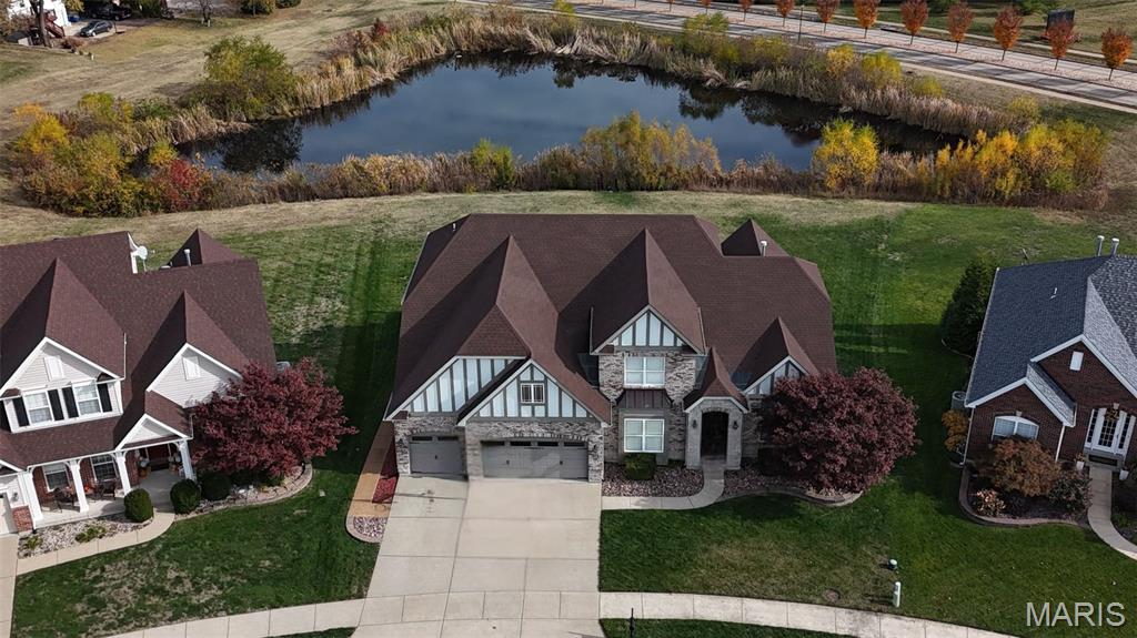 Luxurious brick & stone 1.5 story nearly 7000 sq ft estate  in Talbridge Estates. This Fischer & Frichtel home features 4 bedrooms and 5 bathrooms with the master suite on the main level with a huge glass shower door, dual vanities and a soaking tub.  New Carpet throughout and updated paint. The grand foyer leads to a sophisticated living room or dining room, and an additional piano room, setting a serene tone. 12-foot ceiling on the main floor and 20-foot cathedral ceilings in the great room. Open Floor Plan to entertain guest and a Tuscan-inspired kitchen with granite counter tops to enjoy at your leisure with lake views. Upstairs are three spacious bedrooms, 1 with ensuite bath, additional bathroom, and aloft area to relax. The basement is an entertainment hub with a fifth bedroom, full bathroom, gym, pool table, fish tank, entertainment center, and full bar. A stunning walkout lower level with breathtaking lake views to enjoy. It comes with main floor laundry and ample storage. This estate also has irrigation system and has a huge backyard for family and friends.