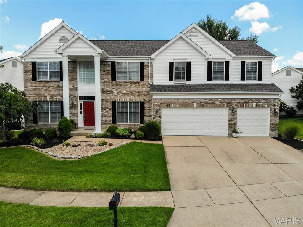 Beautiful two-story home with roughly 5,000 sqft of living space in the desirable Manors at Nottinghill subdivision and award-winning Lindbergh School District! Set on an impressive 100' frontage lot, this home offers a wide side yard with plenty of space for play and outdoor activities, while the backyard features a spacious patio and peaceful waterfall pond. This impressive home offers exceptional curb appeal with a brick elevation, mature landscaping, and a three-car garage. Step inside to a welcoming entry foyer featuring 9-foot ceilings, beautifully stained hardwood floors, and crown molding that extends throughout the entire main level. Decorative columns frame the entrances to the formal dining room and the versatile formal living room, which also makes an ideal home office. The spacious great room is filled with natural light from a wall of windows and features a cozy ventless gas fireplace. The updated kitchen is designed for both everyday living and entertaining, offering 42-inch wood cabinetry, quartz countertops, stainless steel appliances, tile backsplash, buffet and desk area with additional built-in cabinetry, and an adjoining breakfast room with access to the beautifully landscaped, level backyard. Relax or entertain outdoors on the patio overlooking the tranquil koi pond. A spacious main-floor laundry and mudroom with built-in shelving adds everyday convenience. Upstairs, you'll find a versatile loft, an expansive primary suite with vaulted ceilings, a walk-in closet, and a luxurious ensuite bath featuring dual vanities, a walk-in shower, and a soaking tub. Three additional generously sized bedrooms—all with walk-in closets—are complemented by a full bath and a Jack-and-Jill bath. The finished lower level is the ultimate entertainment space, complete with a large wet bar featuring a built-in mini refrigerator and a dedicated theater room with projector and theater lighting. Ideally located near shopping, grocery stores, restaurants, and a hospital, this home also offers peace of mind with major updates including a newer roof (2025), HVAC and furnace (2021), and both water heaters (2021). This move-in ready home truly has it all!  Personal property included with sale: pool table, foosball table, shuffleboard table, all outside planters, refrigerators, washer & dryer and outdoor gas grill.