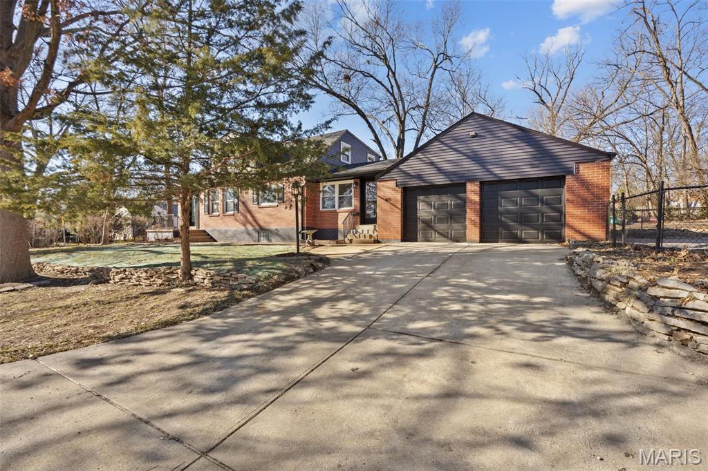 Adorable, updated bungalow bursting with charm and whimsical character—set in desirable Kirkwood with an unbeatable school district. This home beautifully blends modern upgrades with timeless details, thoughtfully preserved to highlight its original personality. Enjoy peace of mind with a brand-new roof plus fully updated electrical and plumbing systems. The reconfigured floor plan offers a spacious primary suite on the second floor, complete with a standout ensuite bath featuring beautiful tilework and exposed brick—truly one of a kind.

The open-concept kitchen flows seamlessly into the living and dining areas and includes a peninsula that’s perfect for entertaining. A generously sized dining room with a vaulted ceiling provides plenty of space for hosting gatherings and making memories.

Downstairs, the full unfinished basement offers abundant storage and is already equipped with a sump pump and drain tile—ready to finish if desired. Outside, you’ll love the large lot with a fully fenced yard, paver patio, and a rare two-car garage.

New construction is popping up nearby—both in front and next door—highlighting the area’s strong demand, yet this home offers something new builds can’t: stunning mature trees along with established landscaping that create true character and curb appeal.

Every update was completed with care to enhance comfort and functionality while keeping the charm that makes this home so special. Don’t miss it!