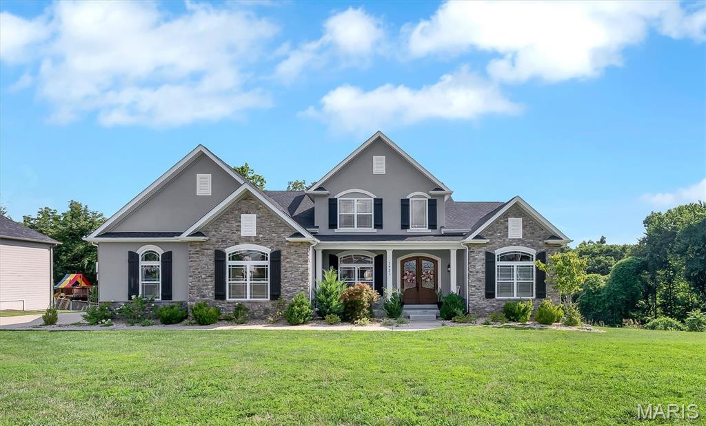 Welcome to 2922 Christopher Dr. Built in 2019, this exceptional custom home seamlessly blends luxury, comfort, and thoughtful design in the highly sought-after Oakville High School district. Offering over 5,800 sq ft of living space on more than a half-acre, this 5-bedroom, 4.5-bath home is loaded with premium finishes and amenities. Step through the impressive 8' front door into a light-filled interior featuring soaring 20' ceilings in the great room, hardwood floors, crown molding, coffered ceilings, custom built-ins, and two gas fireplaces in the great room and hearth room. The chef's kitchen is truly a showpiece with an 8' center island, 42" custom cabinetry, Sub-Zero refrigerator, premium appliances, integrated Miele coffee system, ice maker, wine cooler, wet bar, and abundant workspace. The main-floor primary suite offers a private retreat with heated bathroom floors, dual vanities, a spacious walk-in closet, and spa-like finishes. A dedicated office, formal dining room, mudroom, and main-floor laundry add everyday convenience. Upstairs, you'll find three generously sized bedrooms, each with walk-in closets, along with two full baths. The finished walk-out lower level is built for entertaining with a theater room featuring power reclining home theater seating, motion-sensor stair lighting, a fifth bedroom, full bath with heated floors, and plenty of additional living space. Enjoy the outdoors from the covered composite deck overlooking the fully fenced backyard. Additional highlights include dual HVAC systems, a 3-car HEATED garage, abundant natural light, and craftsmanship that is evident throughout. This is luxury living at its finest in one of South County's most desirable locations. INCLUDED: hot tub, outdoor tv, all appliances in kitchen, washer, dryer, theatre seating, lower level fridge, garage fridge and garage freezer, projector and projector screen in sale.