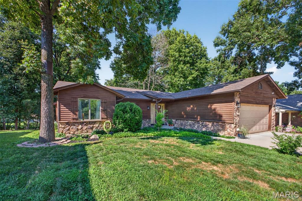 This beautifully updated 4-bedroom, 3-bath home filled with warmth, character, and cozy charm is looking for it's next owners to create memories. The functional kitchen features timeless white cabinetry, abundant counter space, and a spacious eat-in area perfect for everyday meals. (Refrigerator-2025, Dishwasher-2022, Disposal-2021, Electric range-2026.) The separate dining room flows seamlessly into the inviting living room, where an electric fireplace and skylight (w/electric shade) create a bright yet relaxing atmosphere. The primary suite offers a stylish, moody retreat with an updated private bath. Two additional main-floor bedrooms allow for flexibility, with one currently serving as a home office. The finished walk-out lower level expands your living space with new luxury vinyl flooring, a second full kitchen, fourth bedroom, full bath, laundry room, generous storage, and endless possibilities for guests, multi-generational living, or entertaining. Outside on the new (2025) expansive deck, enjoy your view of the fully fenced backyard featuring a patio, playset, and established vegetable, fruit, and flower gardens ready for your personal touch. HOA amenities include a neighborhood pool, tennis courts, and clubhouse, offering the perfect blend of comfort, convenience, and community.  **New attic insulation-2025, Hot-Water heater-2025, HVAC-2020, Driveway-2021
**Rare opportunity for qualified buyers to take advantage of a USDA assumable loan at a rate we haven't seen in years!