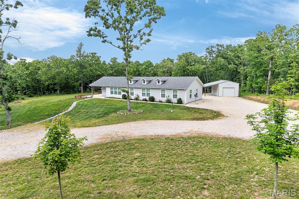 Privacy, acreage, and outdoor adventure all in one! Located on just under 5 acres and literally the home sits on a forestry road heading to Mark Twain National Forest, this 2018-built home offers the perfect setup for hunters, outdoor enthusiasts, and anyone looking to enjoy nature while still being conveniently located on the way to Fort Leonard Wood.

Enjoy nearby ATV and dirtbike trails, hiking trails, and access to thousands of acres of National Forest land right down the road.

Inside, the open-concept layout is filled with natural light and features stained epoxy floors with radiant heat, a custom kitchen with white cabinetry, stainless steel appliances, and a large center island. The home offers 3 bedrooms, 2 bathrooms, walk-in closets, and a spacious primary suite with soaking tub, separate shower, and double vanity.

Outside features include a detached garage with workshop/storage space and a lean-to perfect for equipment, recreational vehicles, or hobbies. If you’ve been searching for privacy, modern finishes, and outdoor recreation nearby, this property is a must-see!