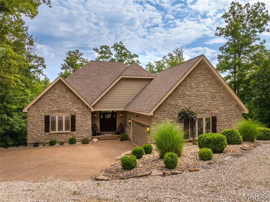 Discover an exceptional single-family residence at 2345 Alpine Overlook Dr, Innsbrook MO 63390, constructed in 2007. This luxury home is in great condition, showcasing amazing design and top-tier materials throughout, offering a truly elevated living experience. The heart of this home is an open-plan kitchen, seamlessly integrated with the living room, designed for both culinary artistry and social gatherings. It features matching black appliances, including a double oven, complemented by both an island and a peninsula, providing ample space for preparation and casual dining. Adjacent to this, the living room invites relaxation with its comforting fireplace, perfect for cozy evenings. Each of the three bathrooms provides a spa-like retreat. One bathroom offers a jetted bathtub and a double vanity, while another features extensive storage, a walk-in shower, and a rainfall shower head, creating a luxurious escape. Another bathroom boasts a shower with multiple shower heads, ensuring a rejuvenating experience. Beyond the main living areas, this property extends its appeal with an indoor wet bar, ideal for entertaining, and a practical laundry room for everyday convenience. The attached garage provides secure parking and additional storage. Step outside to a patio and a large deck, perfect for enjoying the outdoors, or gather around the fire pit for memorable evenings. The private dock offers direct access to water activities, enhancing the lifestyle this property affords. This remarkable property is an invitation to embrace a life of comfort and sophistication. Call today for a guided tour of this property and see for yourself all this has to offer!