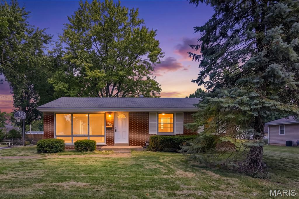 Welcome to 125 W Saint Anthony, located on a corner lot in the heart of Florissant! This all brick three bedroom, one and half bath ranch is ready for a new family. Hardwood floors and fresh paint greet you as you enter the home. The spacious living room boasts a huge picture window allowing for tons of natural light. The living room leads to the dining area giving the home a nice, open feel. Adjacent to the dining area, you will find the charming kitchen with tasteful cabinetry, stainless steel appliances (including new microwave!), and new laminate countertops. Down the hall, there are three bedroom and full bath. The bathroom features charming wainscoting, updated lighting, and a newer vanity. The primary bedroom contains a half bath for your convenience. The home has a full basement just waiting for your finishing touches or offering plenty of storage space. Come check out this great home in a great location on a great lot!