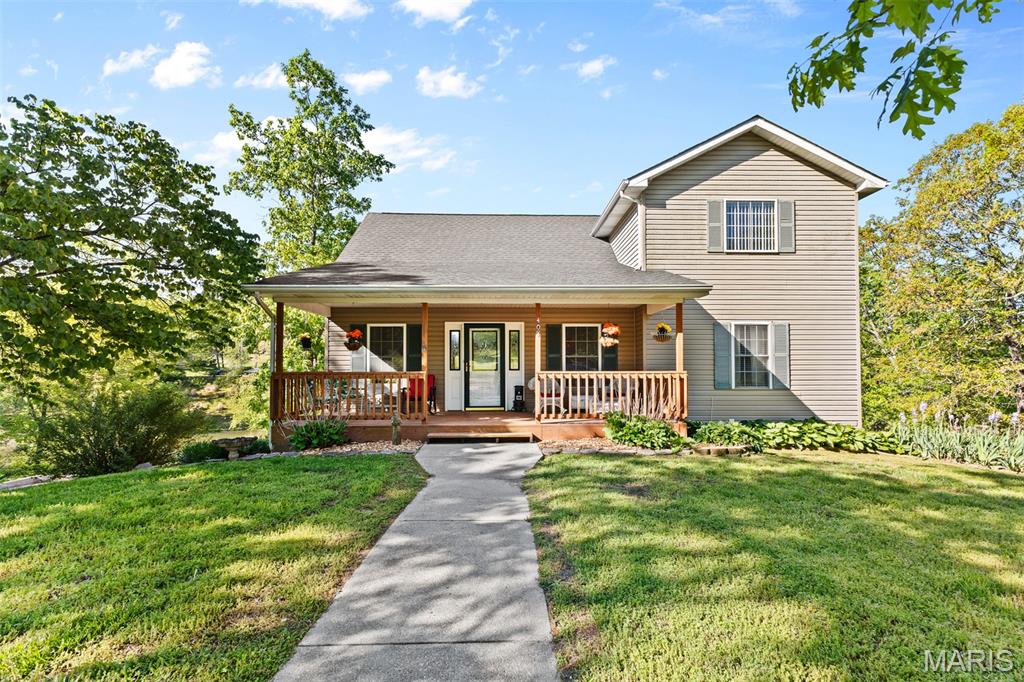 Super cute, fully remodeled 3 bedroom 3 bath lake home with stunning lake views! This home features a completely renovated kitchen and bathrooms, all new lighting, tilt-in windows, sliding doors, flooring and blinds. Enjoy peace of mind with a brand new HVAC system (inside and out) with a 10 year warranty and newer roof in 2022. Step outside to your very own lakeside oasis with newer decks and a brand new dock.  The lower level is made for entertaining with a bar and plenty of space to look out and enjoy the lake view. This lake community offers boating, skiing and some of the best fishing around. This home is beautifully maintained and move in ready!
