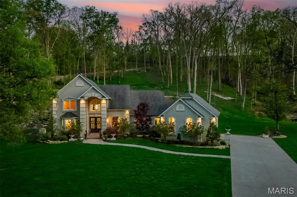 Tucked away on 3 private acres, this breathtaking 1.5-story retreat offers peaceful creekside living with stunning bluff views and unmatched privacy. From the moment you arrive, you’ll appreciate the thoughtful updates including new Pella windows perfectly framing the scenery, a beautiful ProVia double entry door, new exterior doors, can lighting throughout, whole-house generator, and a smart technology package. The garage is a dream with high-rise door lifts and sleek epoxy floors.
Inside, you’ll find fresh carpeting upstairs, 4 full baths plus a powder room, and a well-appointed kitchen featuring 42” cabinetry, a new glass cooktop, and a center island ideal for gathering. The main-floor primary suite is a true escape with a bay window slider opening to your own private green space—perfect for a future hot tub—along with dual closets, a soaking tub, and a picture window view you’ll never tire of.
The finished lower level offers incredible flexibility with two bonus rooms (office, theater, fitness), a spacious family room, full bath, and abundant storage. The dramatic 2-story great room with fireplace and vaulted ceilings flows into a light-filled 4-seasons room, creating the perfect setting to relax or entertain year-round. This home is truly special—see agent remarks for additional lot opportunity at 5516 Elk Valley Estates.