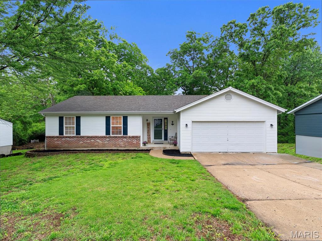 Price Adjustment.  3-bedroom, 3-bath ranch in Ofallon Hills offers 1,940 sq ft on a .236-acre wooded lot in Wentzville R-IV school district. Hardwood floors flow through the living room, dining room & kitchen. Bright 18x13 living room is open & inviting. Kitchen has been expanded and features ample cabinetry, s/s appliances & connects seamlessly to dining area. All 3 bedrooms on main level, including primary suite with private bath. Finished lower level adds 610 sq ft & full bath — perfect for rec room or home office. Backs to serene trees and a small creek that is great for exploring. Covered front porch, brick accents & 2-car garage elevate the curb appeal. Don't miss out on this one!