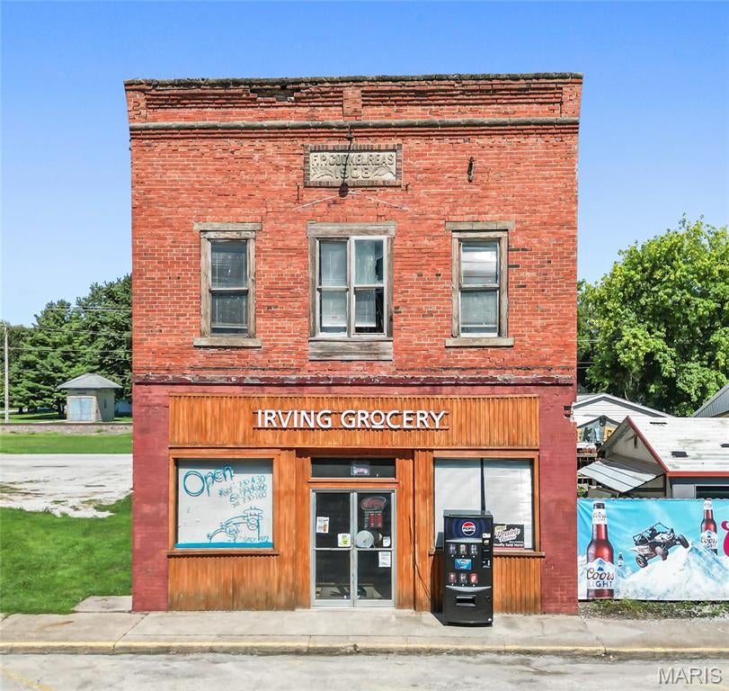 STEP BACK IN TIME WITH THIS ONE-OF-A-KIND IRVING LANDMARK! With roots as a grocery store dating back to 1908, this historic commercial property has been a fixture in the community for more than a century and offers an opportunity that is truly difficult to duplicate!

The approximately 2,500 square foot main level is filled with original character, featuring impressive 12-foot ceilings, original tile ceilings, wood floors, and even the original operational checkout counter. From the moment you walk through the door, the charm and history of this longtime neighborhood store are unmistakable.

Currently operating as a full-service grocery store, the property has also become a favorite local stop for a quick lunch, known for its roller-style hot dogs and sandwiches. A traditional butcher shop offering hand-cut meats has been another longtime staple of the business. The main level includes grocery fixtures and shelving, a butcher and meat preparation area, two walk-in coolers, a refrigerated meat display, and related store equipment.

BEST OF ALL, THIS IS A TRUE TURNKEY BUSINESS OPPORTUNITY! The sale includes the business, fixtures, equipment, and remaining inventory, with the exception of one butcher block the owners plan to retain. Other than that, the keys are yours to continue the operation and carry on a tradition that has served the Irving community for generations!

CURRENT STORE HOURS are Monday through Friday from 7:30 AM to 4:30 PM and Saturday from 7:30 AM to 1:00 PM, giving the next owner an established operating schedule with plenty of opportunity to expand hours if desired.

And there is even more potential upstairs! The second story offers approximately 2,500 additional square feet that could be renovated and reimagined into apartments, a spacious studio, office space, or another use to complement the main level. The original exterior staircase was removed years ago, so access to the second floor would require construction of a new interior or exterior staircase as part of any future renovation.

The current owners purchased the property in 1972 and, after more than five decades of ownership, are ready to retire and pass this special piece of Irving history on to its next owner.

Offering approximately 47 feet of frontage along heavily traveled Illinois Route 16 in downtown Irving, the property enjoys excellent visibility and convenient access. Located next to Grandma's Kitchen and the Irving Post Office and across from Bank & Trust, this is a prime downtown location with tremendous possibilities.

HERE'S WHERE THE OPPORTUNITY GETS EVEN BETTER! The neighboring Grandma's Kitchen property and business, MLS #26057720, is also being offered for sale. The restaurant currently purchases meats and other supplies from this grocery business, creating a natural relationship between the two established operations. Imagine the possibilities of purchasing both properties and businesses and having a grocery store, butcher shop, restaurant, gaming operation, and additional upper-level space all working together in the heart of downtown Irving!

Purchase this property on its own and continue a tradition that has lasted for generations, or take advantage of the rare opportunity to acquire both neighboring properties and bring an entirely new vision to this downtown location. THE POTENTIAL IS ENDLESS. IF YOU CAN DREAM IT, YOU CAN MAKE IT HAPPEN!