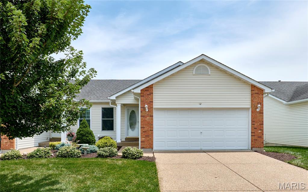 Enjoy the ease of villa living in this spacious home in O'Fallon! Located in the Villas at Highgrove, you'll have access to the community swimming pool, pond, and walking trails. Beautiful landscaping, brick accents, and a covered front porch make for great curb appeal. You'll love the open layout of the main living space, with vaulted ceilings and gleaming hardwood floors connecting the living room and dining room and continuing into the bedrooms. The kitchen features a breakfast bar, tile backsplash, and tile floors. A bay window off the living room leads to the back deck. The primary bedroom has a walk-in closet and en-suite bathroom with a large vanity and tile-surround step-in shower. Another bedroom, full bathroom, and convenient main-floor laundry complete the space. The walk-out finished basement adds a family room with a wet bar, third bedroom suite w/walk-in closet and bath w/step-in shower, plus a workshop area in the unfinished storage space. You'll have even more storage in the two-car garage with built-in cabinets, as well as an accessible ramp to the door. You'll love grilling with friends on the deck overlooking the backyard and walking trail. Moments from Main Street O'Fallon, Dames Park, and Ft. Zumwalt Schools, with quick access to I-70 and all of the restaurants and shopping on Hwy. K, this home in a great location is one you won't want to miss!