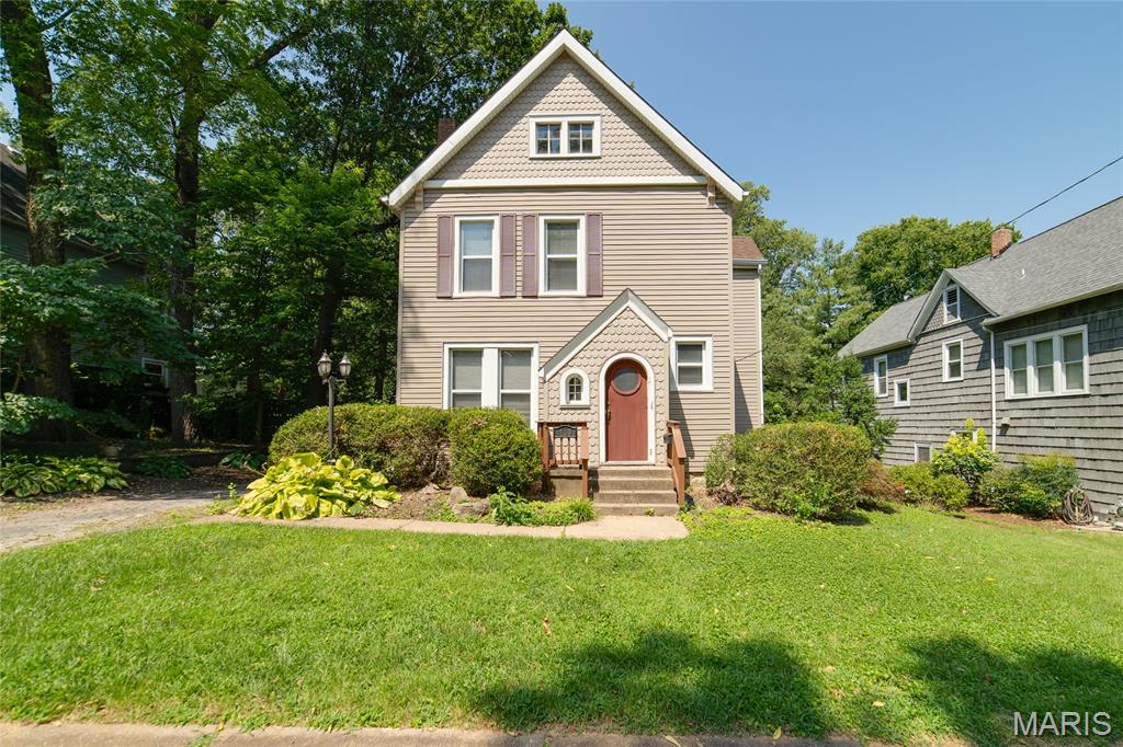 You will love the curb appearance of this treed lot with its charming arched entryway; a special place you can call home. Older 2 story, 3 bed, 9ft. ceilings, 1 and 1/2 bath, fireplace, home on level lot. So convenient for the area, walk to stores and restaurants, College and Hwy 44 in 2 minutes or less yet set in a quiet neighborhood. Covered back patio and enclosed patio on second level. Stairway to upper 3rd floor storage, walkout basement and a great opportunity to update this home to your tastes. Unique handmade paneling in stairway was from the dance floor on the Admiral Ship in St. Louis along with all the charm from a older Webster home. Call for a viewing and come make this your home.