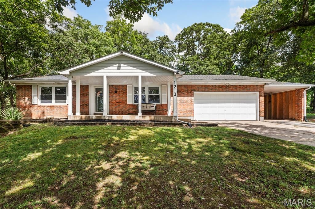 RARE FIND! Opportunities like this don't come often... Updated ranch on nearly 6 beautiful acres, and just 2 minutes from all the shops & restaurants in town. Wonderfully maintained with so many recent updates including roof, windows, HVAC & more. Fantastic curb appeal with large covered front porch & landscape beds welcoming you into the light & bright living room with charming accent wall, spacious dining room with gorgeous hardwood floors that flow into a bright white kitchen with built-in shelves, black hardware & updated light fixtures throughout. Just off the dining room, you'll find the most relaxing screened patio overlooking the private fenced yard & acres and acres of wooded land, plus an adjoining open-air patio perfect for grilling, and a large fire pit. Two spacious bedrooms with very generous closets, a full bathroom, & multiple hall closets round out the main floor. The partially finished, walk-out lower level features a fantastic rec room with wood-burning brick fireplace, another full bath, huge storage room, plus two egress windows allowing the perfect setup to add another bedroom or guest space. So much parking with oversized 2 car garage, enclosed carport, and additional parking pad, plus even more storage space in the backyard shed. Beyond just the home, this property features nearly 6 acres of ideal landscape with gently rolling elevation and trails already made for the dirt bike hobbyist. Roof, windows, electrical, water heater, & high-efficiency heat pump HVAC have all been updated in very recent years. Come for the inviting, move-in-ready home... stay for the tranquil, private acreage you so rarely find.