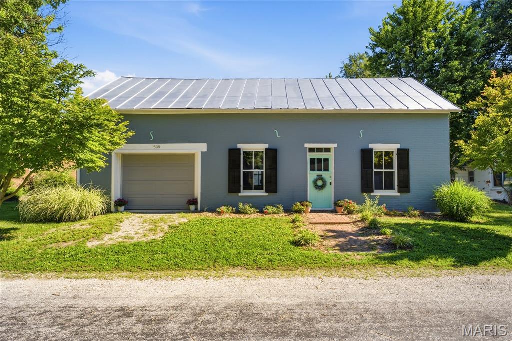 Unique opportunity in the heart of Millstadt! This historic German-vernacular brick building offers a rare blank canvas with strong structure and flexible potential. The exterior features a freshly painted facade and durable metal roof, while the main level has been updated with defined multi-room spaces, painted floors, and insulated ceilings.

Inside, you’ll find a versatile main area ideal for studio or workshop use, a dedicated workshop room, and an integrated garage bay(manual). A permanent staircase leads to a massive, floored 1.5-story attic loft—offering exceptional storage or future expansion potential.

The property has active electrical service in place. Please note: the structure does not currently have water or sewer infrastructure (no city hookups, well, or septic system on site).

Included architectural concept plans illustrate a potential residential conversion, showcasing how the space could be transformed into a fully functional living layout.

A perfect opportunity for investors, contractors, hobbyists, or creative buyers seeking a unique renovation project or studio space. Sold strictly AS-IS. Buyer to verify zoning, permitted uses, and all utility tap fees.