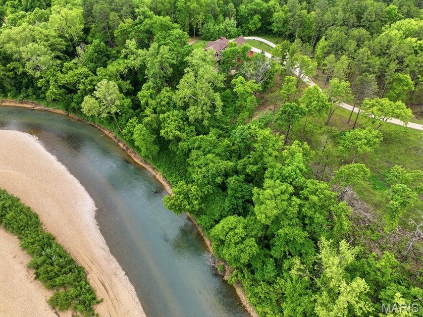 Build your dream getaway in the heart of the Ozarks with this rare opportunity to own riverfront property on the beautiful Jacks Fork River in Eminence! Seller is offering newly divided riverfront lots, providing the perfect setting for a vacation home, cabin retreat, Airbnb investment, or full-time residence. This 0.79± acre lot offers access to city water, sewer, and electric, making development even more convenient. Owner is retaining one adjoining lot which will include a private road down to the river. Purchasers of the riverfront lots will have shared access to use the road for easy river access and enjoyment of all the beauty the Jacks Fork has to offer. Enjoy floating, fishing, kayaking, swimming, and relaxing right from your own property. Located just minutes from downtown Eminence, restaurants, shopping, and thousands of acres of Mark Twain National Forest, this is an excellent opportunity to own a piece of one of Missouri's most desirable recreational areas. Rare small-acreage riverfront tracts with utilities available are hard to find--don't miss your chance!