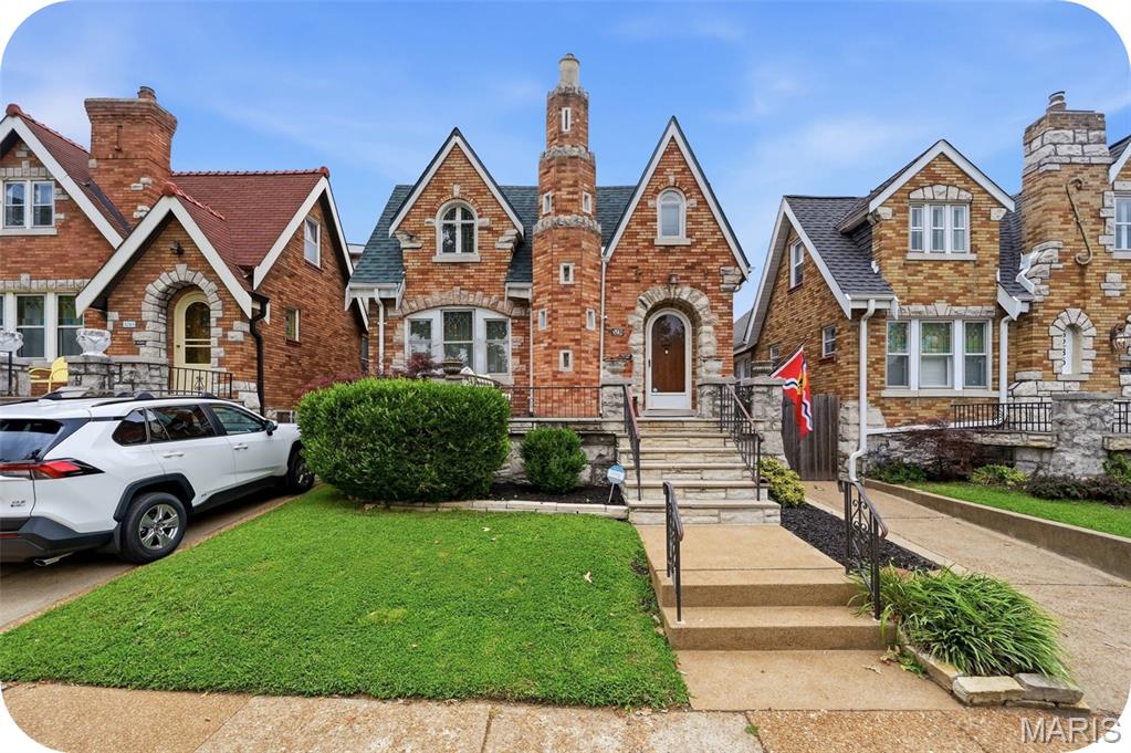 Looking to own your very own castle?  This might be your chance! This adorable gingerbread home has its very own turret and some of the best curb appeal in Northampton. Blonde brick, stone accents, a rounded front door, a charming front porch, and that turret will make your heart go pitter patter! 

Step inside to a cozy foyer area where you can hang your coat, drop your keys and continue into the warm and inviting living room featuring exposed brick, a fireplace with mantle & working sconces and floor-to-ceiling brick detail. The spacious dining room is ready for your guests! Kitchen is wonderful, featuring plenty of storage & counter space.  Beautiful solid-surface counters,  a large island with seating, subway tile, black appliances, a spice rack and lovely cabinets.   There are TWO generous bedrooms on the main floor. The updated main floor bath is a showstopper with gorgeous  floor tile that resembles stamped leather from Spain-ooh-la-la!  

Upstairs, the owners suite gives serious royalty vibes. With two charming window nooks, tons of space, adorable rounded stained-glass windows, and plenty of closet space- you may never want to leave. The large en suite bath features a double sink and walk-in shower. A FOURTH bedroom completes the upper level.  Bonus: wood floors run throughout both levels. The bright multipurpose sunroom leads to a fenced backyard and a garage that offers TWO garage doors- one to access the alley and one to access the yard! How convenient! 

Come see what all the fuss is about in Northampton! Home to Bud's Pizza & Beer, The Golden Hoosier, Piper's Cafe, and recently reopened Uncle Bill's!  Walk to Tilles, Sublette and Tower Grove Parks!  Many updates including NEW ROOF June 2026! You'll feel like royalty living here!  Come quick!