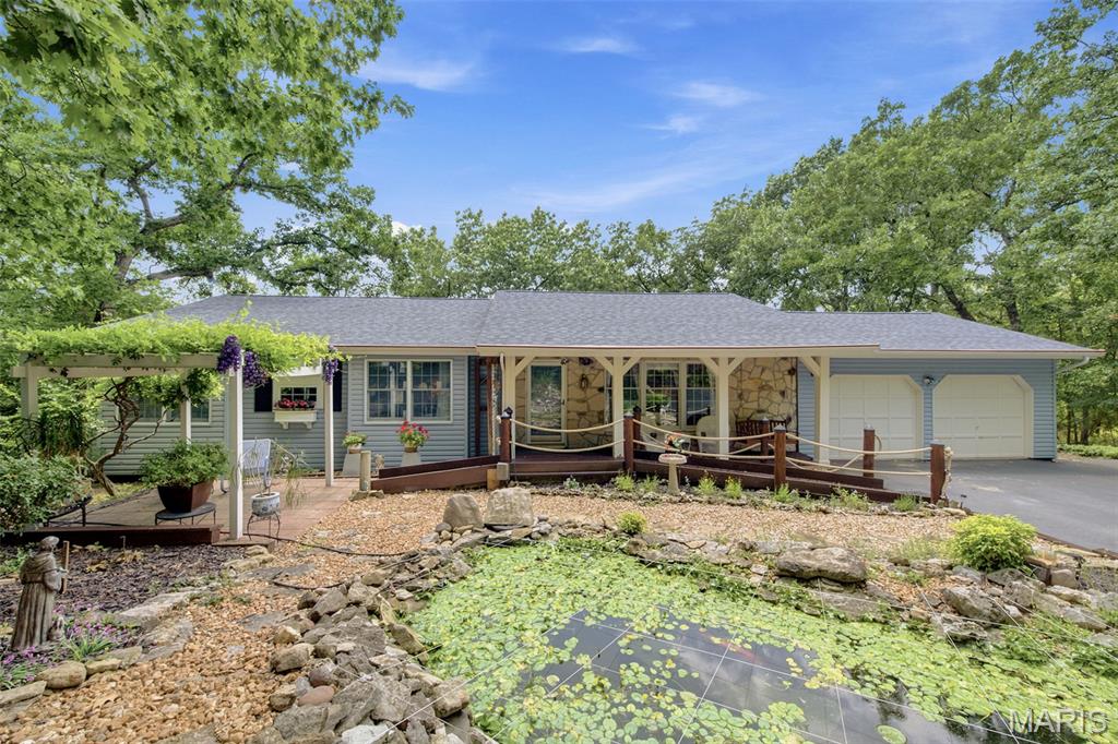 Nestled on 2 private, tree-lined acres in the desirable High Trails subdivision, this beautifully maintained ranch offers the perfect blend of peaceful surroundings and comfortable living. Built in 1978, the home welcomes you with timeless curb appeal, highlighted by a charming koi pond, mature landscaping, and multiple outdoor spaces designed to enjoy the natural setting.

Inside, the updated kitchen features vinyl flooring, a classic subway tile backsplash, hard-surface countertops, peninsula seating, and a cozy breakfast nook. The spacious great room is filled with natural light and showcases a striking floor-to-ceiling stone, wood-burning fireplace that beautifully echoes the home's exterior stonework. The main level offers 3 generously sized bedrooms with large windows, including charming bay windows that bring in abundant natural light, complete with 2 bathrooms.

The partially finished walkout lower level expands the home's living space with a second stone fireplace, an additional bedroom, laundry, versatile flex spaces, and a secondary staircase leading directly to the kitchen corridor for added convenience.

Step outside to enjoy the tranquil backyard from the partially covered deck or walkout patio below, all surrounded by mature trees that provide exceptional privacy. Whether you're entertaining, relaxing, or simply enjoying nature, this property offers a peaceful retreat just minutes from everything Eureka has to offer.