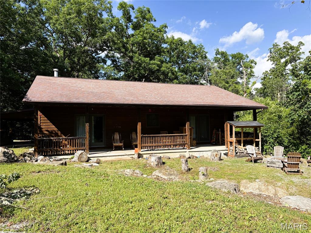 Spacious 3-bedroom 2-bath lakeview cabin at Pinnacle Lake!  Home offers plenty of room for family and friends, with a flow towards entertaining. Living room, dining room and kitchen are all open to one another so nobody's left out of the fun. The living room features a woodburning stove, built in bar and wine cooler, dining area will easily fit an 8–10-person table, kitchen meshes well and features breakfast bar, space for future dishwasher, newer stove and microwave, plus door to deck, and a utility room that is conveniently accessed from kitchen and hallway.  At the end of the day, you'll enjoy the privacy of this split bedroom design. Tucked down the hall you discover the large master suite sporting dual walk-in closets, full bath, and access to the covered porch. The opposite end of the home features 2 more bedrooms and another full bath. The walk out basement is set up with an entry door, window and an overhead door for lake toy storage. All this sitting on 3 lots totaling just under an acre. The perfect lake getaway or live the lake life year-round.