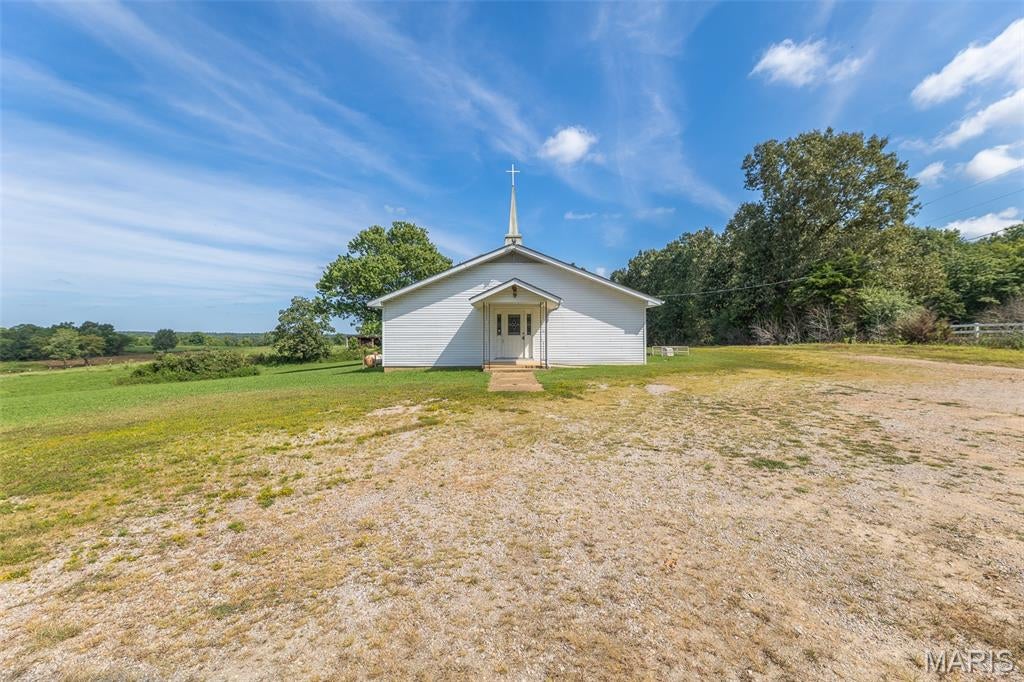 Discover the possibilities with this unique property nestled in a peaceful country setting on 1.86 acres! Previously used as a church, the property offers a versatile layout featuring 4 half bathrooms and potentially 2 bedrooms, providing plenty of flexibility for a variety of uses. Whether you’re looking to continue its current purpose, create a unique residence, establish a retreat, or bring another vision to life, the possibilities are endless. Enjoy the privacy and peacefulness of the country while still having a property full of potential. Bring your ideas and make this one your own!