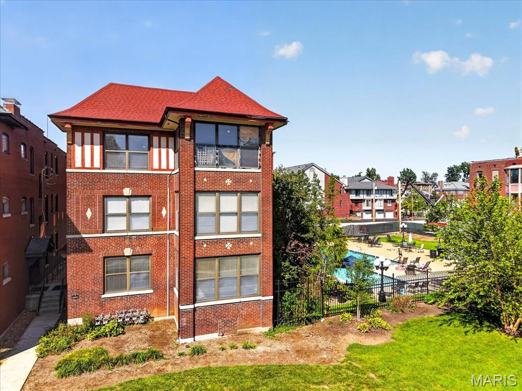 Experience DeBaliviere Place living in this classic 1914 brick building situated right beside the neighborhood swimming pool, quick access to Forest Park and nearby universities! The ground floor unit combines timeless character with modern upgrades. Unwind in the spacious living area anchored by a the wood-burning fireplace, recessed lighting, and beautiful wood floors. The galley kitchen showcases granite counters, classic subway tile backsplash, and stainless appliances, paired with in-unit main-floor laundry. The second bedroom features 3 walls of windows and the room could be used as an office. Association perks include secure enclosed parking, building security, water/sewer, exterior maintenance, and a fitness center around the corner. If you are hoping to purchase an affordable unit within reach of Forest Park, this is the condo that you need to tour!