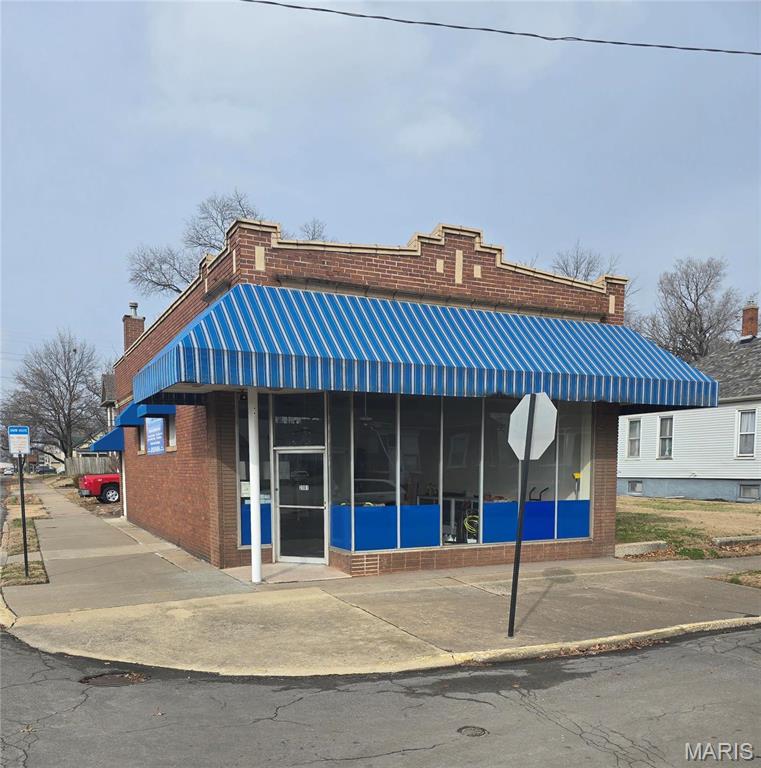 This building has served us well and now, it is time for a new owner.  The large open space was used for office area, storage and staging of our commercial janitorial company.  Prior to our use, it served the community as a locally owned confectionary and drug store.  The main room still has the original high, ornate ceilings with fresh paint, new luxury vinyl tile and carpet.  Recently, the bathroom has been updated as well.  The a/c was used for one season and then moved to the interior for the winter.  If the buyer desires, it will be re-installed prior to closing.  This building also has a full basement with shelving along the parameter and a center workbench.  Located on a corner lot which includes the grassed area on the side of the building.  The building has been well maintained and being sold, 'as,is'.  There is a loading zone and street access into the building.  It is zoned R3 and would make a nice office, salon, low-traffic business or storage.  The property is Agent Owned. Location: Corner Location