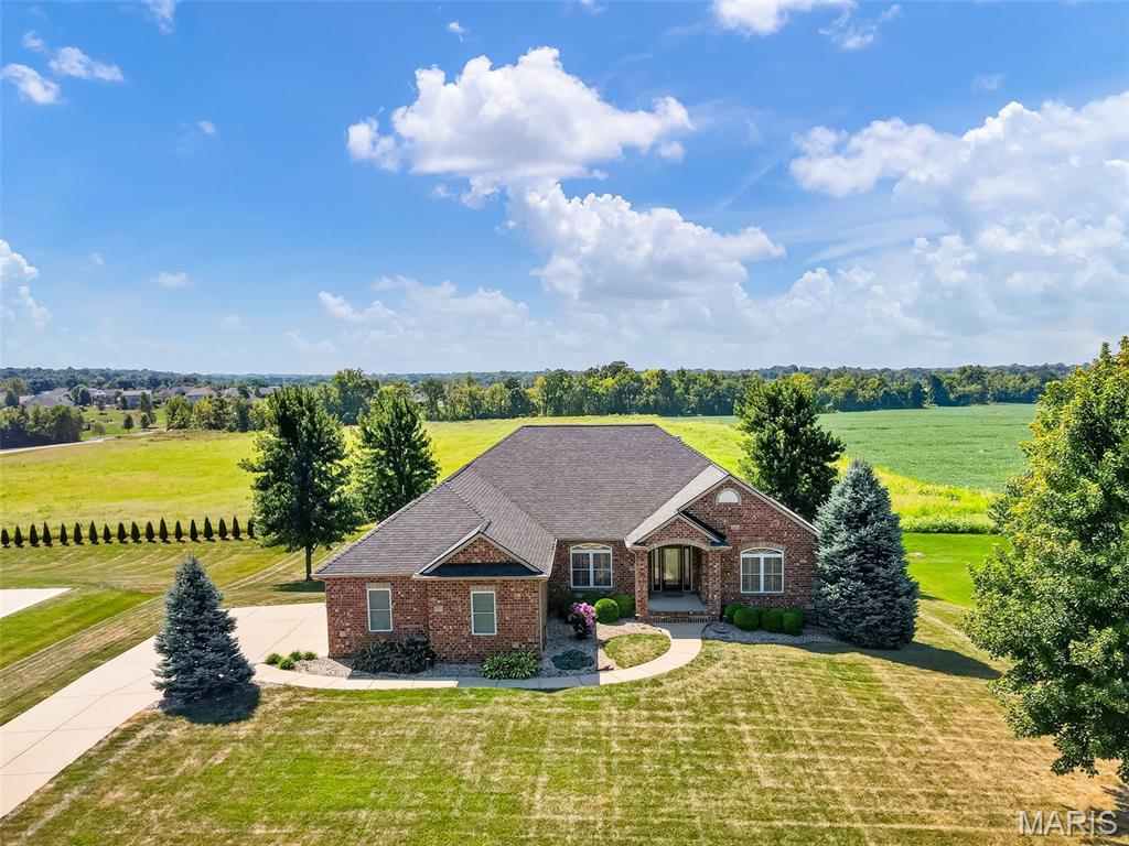 A rare opportunity in Columbia’s highly regarded Brellinger subdivision. This impressive all-brick ranch offers nearly 4,000 square feet of finished living space on a beautifully landscaped .68-acre lot, combining timeless design, generous proportions and the convenience of true main-level living. The thoughtfully designed main level welcomes you with hardwood flooring, a dedicated office and formal dining room with architectural detailing. At the center of the home, the light-filled great room features a vaulted ceiling and gas fireplace, while the adjoining kitchen offers granite countertops, breakfast bar and casual dining with access to the covered deck. All kitchen appliances are included, along with the breakfast table and chairs and island stools, making the transition even easier. Plantation shutters throughout add a polished finishing touch. The spacious primary suite provides a private retreat with a large walk-in closet and ensuite bath featuring dual vanities, soaking tub and separate shower. Two additional bedrooms, a Jack-and-Jill bath, half bath and main-floor laundry complete a floor plan designed to function beautifully for both everyday living and overnight guests. The finished walkout lower level is an extension of the home's living and entertaining space, featuring a second family room with gas fireplace, recreation area, wet bar, fourth bedroom with spacious walk-in closet and direct access to the full bath for a private suite feel. This lower level would function well for multi-generational living as you could transition wet bar into a kitchenette. Even better, several pieces are included with the home—the shuffleboard table, basement sofa and wet-bar stools—so this inviting space is ready to enjoy from day one. Outdoor living is equally appealing with a covered deck and patio overlooking the professionally landscaped yard with irrigation. Additional highlights include a side-entry three-car garage, 9' basement pour, new roof and 6" gutters.

And the location may be one of its best features. Situated on Columbia's north end, 558 LaCroix Way offers convenient interstate access and an easy connection to the greater St. Louis area—ideal for commuting to employment centers or enjoying convenient access to major hospitals and medical centers, shopping, dining, professional services, sports and entertainment while coming home to the quieter pace and community feel of Columbia.