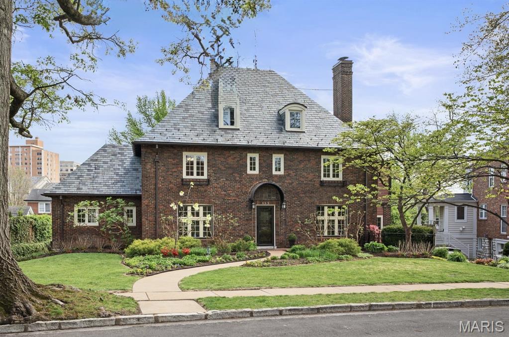 Welcome to 665 W Polo Drive, a distinguished French Norman residence on one of Clayton's most coveted streets. Designed by former resident and renowned architect William Ittner, this 2.5-story home offers 5 Bedrooms, 3.5 Baths, and gracious architectural character throughout. A step-down Entry Foyer introduces the grand Living Room with fireplace and custom screen, beautiful windows opening to a charming Sun Room with concealed bar and access to the side garden,backyard and patio. The formal Dining Room is filled with natural light and well-suited for small and large entertaining. An updated kitchen with stainless steel appliances, Sub-Zero refrigerator, Bosch cooktop, built-in table large enough for 6-8 people, integrates with stunning south facing view and deck with natural gas grill and year round enjoyment, flows to the warm and inviting Family Room. A Main Level Laundry Room and Powder Room complete this floor. The Second and Third floors feature 5 Bedrooms and 3 full Baths, including a serene Primary Suite with updated bath and Sitting Room or a perfect place for an in home Office. The partially finished walk-out Lower Level opens to a private yard and deck and has a full kitchen and tile floor.  Rear entry tuck under garage, tons of storage, wine storage and a bonus tool room.  All new Anderson Windows throughout, except for two irreplaceable windows in the Dining Room and Living Room. Minutes to Forest Park, downtown Clayton, top rated public and private schools and Washington University. Exclude: Dining Room chandelier. This lovely home has been enjoyed by the current family for many years and they are now ready to turn it over to the new owners and know they will enjoy living at 665 W Polo Drive as much as they have!!