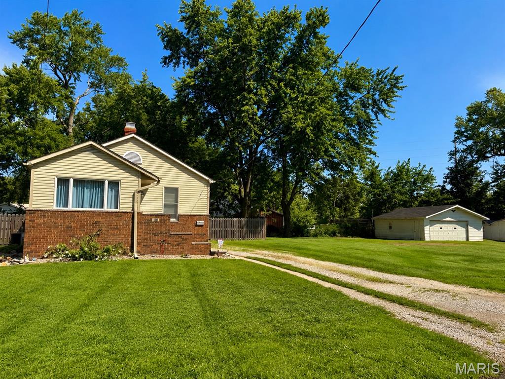Welcome to 411 E. Chestnut Street in Gillespie, Illinois—a place where you’ll have room to spread out, relax, and truly enjoy home.

Imagine sipping your morning coffee while overlooking your expansive backyard, watching children play, dogs run, or planning the garden you’ve always wanted. This property includes two lots totaling approximately 0.61 acre, giving you over half an acre of outdoor space that’s becoming increasingly difficult to find.

Inside, you’ll find a warm and inviting 2-bedroom, 1-bath home filled with natural light and comfortable living spaces. Whether you’re hosting family, enjoying a quiet evening, or simply settling in after a long day, this home offers a cozy atmosphere you’ll appreciate.

The kitchen comes complete with a stove, refrigerator, and portable dishwasher, making move-in simple and convenient.

The full basement provides even more possibilities. While unfinished, it offers excellent additional living space for a recreation room, hobby area, workshop, or home gym, along with abundant storage. An additional toilet is located in the basement, and washer and dryer hookups are already in place.

Step outside to enjoy the fully fenced backyard, perfect for entertaining, pets, gardening, or simply unwinding at the end of the day. The oversized detached garage offers plenty of room for vehicles, lawn equipment, tools, and weekend projects.

Located in the welcoming community of Gillespie, you’ll enjoy small-town charm while being conveniently situated between St. Louis, Missouri, and Springfield, Illinois, with quick access to Interstate 55 for an easy commute.

If you’ve been looking for an affordable home with elbow room,  a spacious yard, and endless possibilities both inside and out, 411 E. Chestnut Street is ready to welcome you home.

Property Features:
• Fenced backyard
• Two lots totaling approximately 0.61 acre
• Oversized detached garage with electricity
• 2 Bedrooms
• 1 Full Bathroom
• Additional bathroom toilet in the basement
• Full basement with bonus living space and abundant storage
• Washer & dryer hookups
• Stove, refrigerator & portable dishwasher included
• Convenient access to Interstate 55, St. Louis, and Springfield