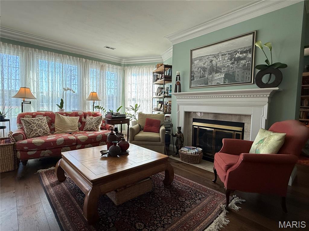 Welcome to Unit 206 at the Ashford—completely rehabbed summer 2018, featuring a private balcony with retractable screen, updated kitchen and baths, and a move-in ready feel. Ideally positioned at the hallway’s end, this unit offers elevator access and proximity to the rear stairwell with direct parking lot access. Inside, you’ll find an updated kitchen, laundry, and utility room with a full-size deep freezer (all included), plus spacious dining and living areas filled with natural light. A cozy den, separated from the living room by a see-through new gas fireplace (2024), creates flexible space for TV, reading, or a home office. The large primary suite includes a walk-in closet, additional closet space, and updated bath with shower. The second bedroom offers built-ins and a wall closet, while the updated hall bath includes a shower/tub combo. Wood floors run through the main living areas, complemented by extensive built-in bookcases throughout. Additional storage is located in the hallway outside the unit and in the garage. Two garage parking spaces and a Beam central vacuum complete the offering.