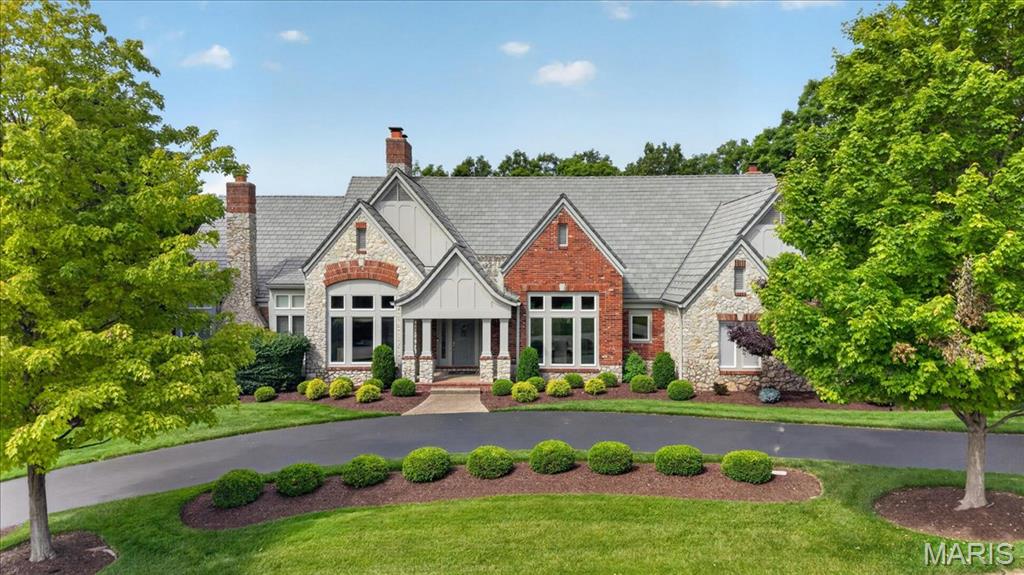 Here is the St Albans Construction built atrium ranch home that highlights superior construction quality and is a home that has been perfectly maintained from its manicured lawn and landscaping to its spotless interiors and exteriors. The stone and brick exterior, slate styled DaVinci roof and circle driveway add to its wonderful curb appeal. Enter thru a beautiful foyer with custom faux painting. All the carpeting on the main floor and on atrium stairway is new in 5/26. The garage floor is epoxy coated. There is a sprinkler system and Beam central vacuum and surround sound music system with dual speakers in every room in the home including garage, deck and patio (excludes 3 bedrooms and office). The home features 4 full masonry fireplaces with gas logs, many high vaulted, wood beamed or trey ceilings, 3 powder rooms with custom faux painting, all bedrooms are ensuite, 8' doors on the main floor, crown molding and wainscoting in the dining room, a Den/Office with double French doors and a wall of built-in bookshelves, a fabulous atrium stairway that captures all the beauty of the treed backyard. Relax on the Trex deck with solar post lighting or on the large aggregate patio in the backyard that backs to landscape lighted trees for privacy and hear the peaceful water feature in the pond behind the house on the golf course beyond. The expansive kitchen features Subzero refrigerator, Viking double convection ovens, Asko Dishwasher, floor kick vacuum, granite countertops, walk-in pantry, vaulted ceiling with wood beams in the kitchen, hearth room and breakfast room. The Primary suite is massive with a private gas logged fireplace, a custom finished 17' x 12' closet, vaulted ceiling, bath with jacuzzi tub and large shower with shower seat. The lower level is perfect for entertaining and for family living or guests visiting. All three bedrooms are ensuite with full bathrooms, large walk-in closets and darkening shades for those who like to sleep in. There is a floor to ceiling stone fireplace with gas logs, a space for billiards and a theater area away from the atrium which is perfect for watching tv. the 3-D theater system is negotiable. The bar features a subzero refrigerator, wine cooler and ice machine. The French door leads to the lower-level patio. The new construction homes being built on the street do not have nearly the features and are costing a much higher price. Twilight/night photos of the landscape lighting will be uploaded soon