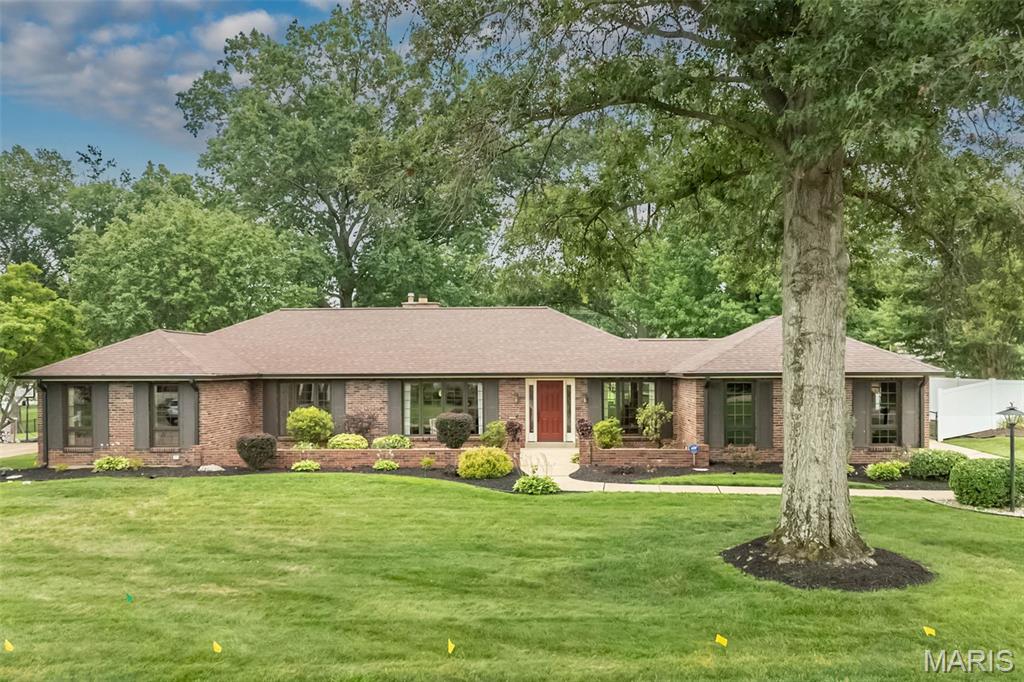 Spacious full brick ranch-style home located in a quiet neighborhood in the award-winning Lindbergh school district. Entering from the front courtyard, the inviting entry foyer leads to well-detailed living and dining rooms with floor-to-ceiling windows that draw in an abundance of natural light. The adjacent family room with beamed ceiling and brick accent wall with raised-hearth fireplace opens to an expansive patio that overlooks the parklike backyard. The main living area transitions into the chef’s kitchen with white cabinetry, quartz countertops, stainless steel appliances and 6’ peninsula and adjoining breakfast room. The primary bedroom offers an appealing retreat with customized walk-in closet and ensuite bath. Three generous-sized additional bedrooms and full hall bath complete the main floor living quarters. Lower-Level entertainment space includes recreation room with 12’ wet bar, game room and family room plus office and full bath. Situated on a .5-acre lot with fenced level backyard with mature trees & paver patio with pergola. Two car rear entry garage, Pella windows, newer roof & HVAC, 5” gutters, newer electrical panel.