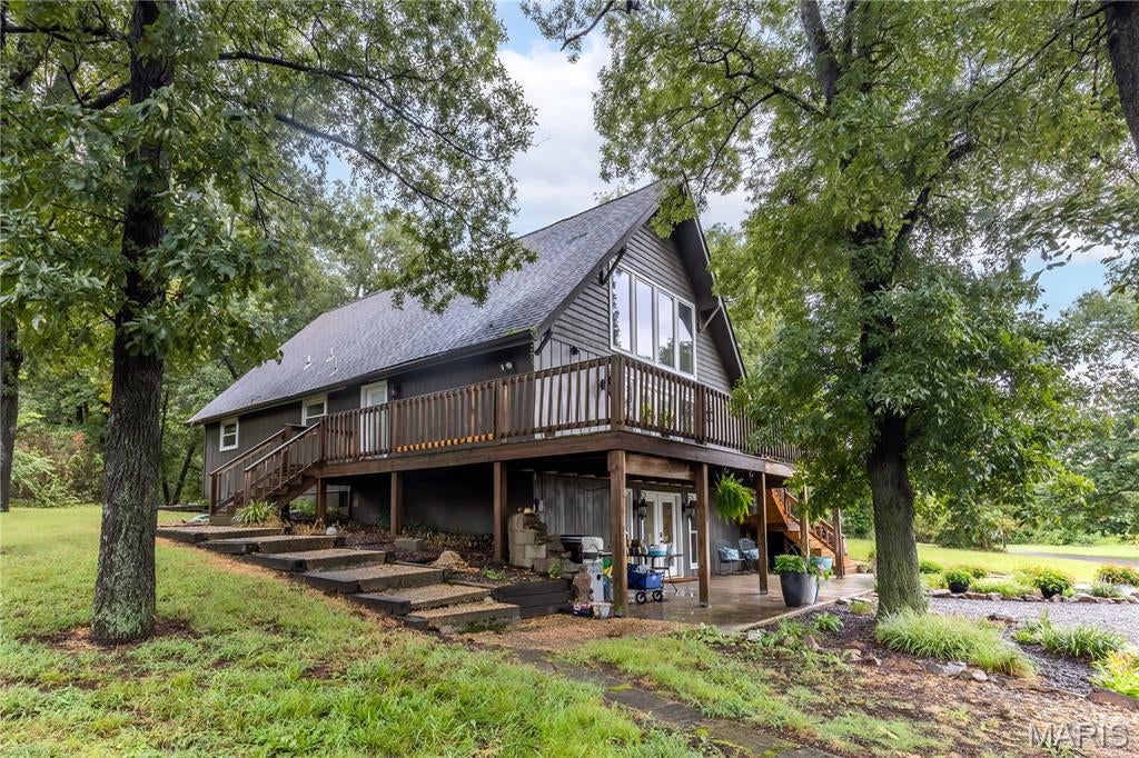 Welcome to country living at its best in one of the area's most private and highly sought-after subdivisions—a location where properties rarely become available! This 4-bedroom, 3-full-bath home sits on 3.17 beautiful acres and offers the space, privacy, and versatility you've been looking for. Inside, you'll find rustic hardwood floors, a cozy fireplace, and a spacious living area with a unique master bedroom balcony overlooking the living room below. The walkout basement provides additional living and storage space with plenty of potential. Outside, the property truly shines with a fenced pasture, newly built metal barn, newly built run-in shed, and an above-ground pool—perfect for enjoying the peaceful country setting. And then there's the bonus you've been waiting for: a "mother-in-law" suite located in the garage, offering incredible potential for guest quarters, extended family, an office, hobby space, or whatever your needs may be. Opportunities like this don't come along often, especially in this coveted subdivision. Come see all this property has to offer!