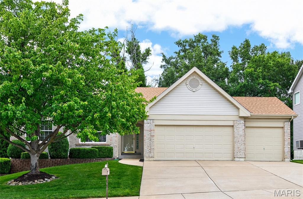 Gorgeous well kept great room ranch homes - meticulously maintained.  This wonderful home offers a private wooded lot, screened in porch to enjoy nature ~ deer, fox and more. composite deck & stairs.  3 car oversized garage with openers.  All of this plus a walk out lower level with full sized windows.  Brick and vinyl sided for easy care, enclosed soffits, roof new in 2025, front windows new in 2017.  The lush green lawn is showcased by an irrigation system with rain guage. Step inside to an entry foyer with neutral ceramic tile. Great room with vaulted ceiling, gas fireplace, and ceiling fan. The kitchen offers ceramic tile, sleek stainless smooth top range, quarts counter tops, built in microwave, refrigerator negotiable.  The light and bright breakfast room with plantation shutters on the upgraded sliding door whihc walks out to the screened porch and grilling composit deck.  The common hall offers a coat closet, linen closet and laundry area (washer & dryer new 2021 are negotiable .  The large primary bedroom offers dual walk in closets and a bay window.  Primary bath with separate tub & shower plus dual sinks.  The well sized secondary bedrooms offer good window placement for furniture, neutral paint and ceiling fans. Upgrades include: shutters, custom blinds, 6 panel doors, updated kitchen appliances, breakfast room updated in 2024. HVAC new in 2016 and yearly maintained.  The walk out lower level with beautiful view of the yard, nice composite porch with handrails, full sized windows for future finish in needed.  Sump pit, electric panel plus one in the garage.  This home offers so much plus location is outstanding - close to park, schools, shopping and dining.  Sidewalks on this side of street.  The attached garage adds a layer of practical convenience to this ranch-style home. Embrace a lifestyle of effortless comfort and understated elegance; schedule your private viewing today.